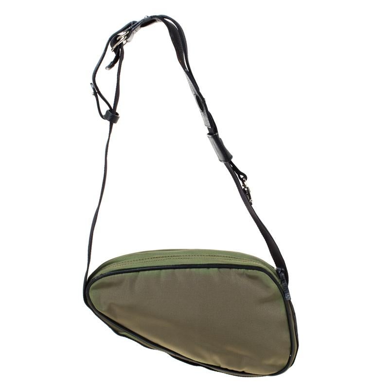 Look extra chic and elegant with this Roberto Cavalli olive green sling bag that's perfect for casual outings. It features a saddle shape, a top zip closure and a butterfly-shaped applique on the front with the brand logo on it. The interior