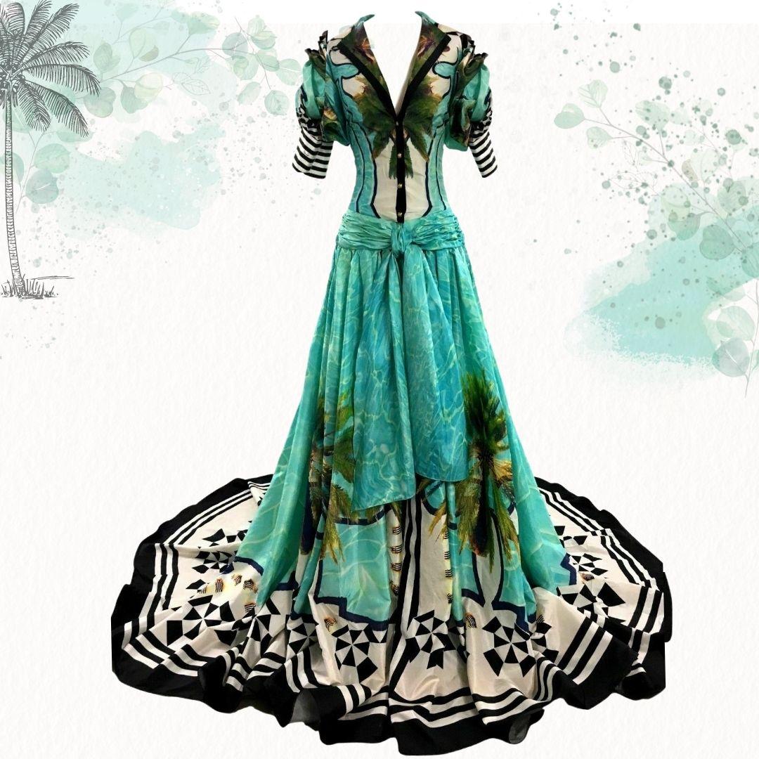 Roberto Cavalli - Evening gown inspired by tropical palm trees and turquoise blue sparkling ocean water.  Dramatic in color and design brings nostalgic thoughts of an escape to a tropical paradise .  The bodice of the dress buttons up the front, has