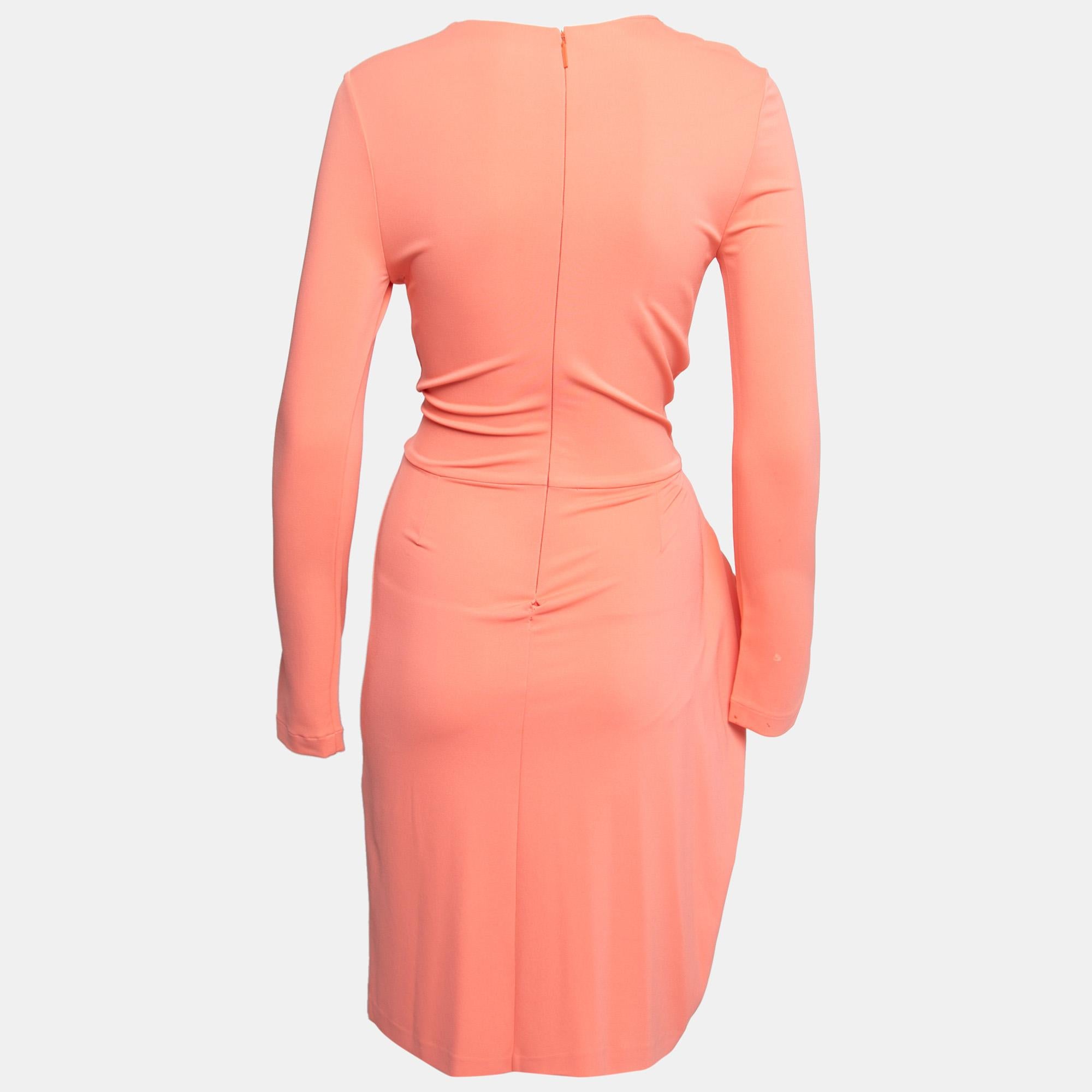 There's truly no better way to feel elegant and graceful than to wear something pretty like this dress. From Roberto Cavalli, this dress is cut from peach jersey fabric, augmented with embellishments, and finished with drapes. This dress exhibits a