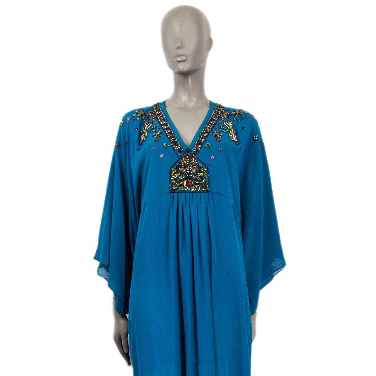 100% authentic Roberto Cavalli caftan dress with crystal embellishment in petrol green silk (100%) with a v neck-line, a cut under the breast and pleated front. Slip-in fit with a deep slit at the front. Semi-lined in petrol green silk (100%). Has
