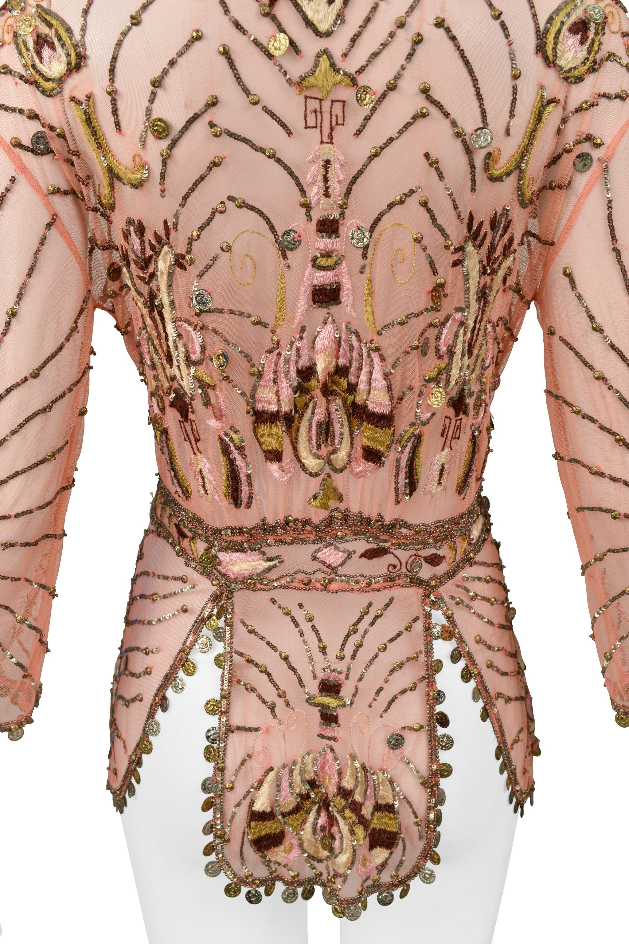 Resurrection Vintage is excited to present a vintage Roberto Cavalli pink mesh jacket featuring gold coin embellishment at edges and throughout embroidered floral print, waistband design outlining, hook and eye closure at chest and embellished
