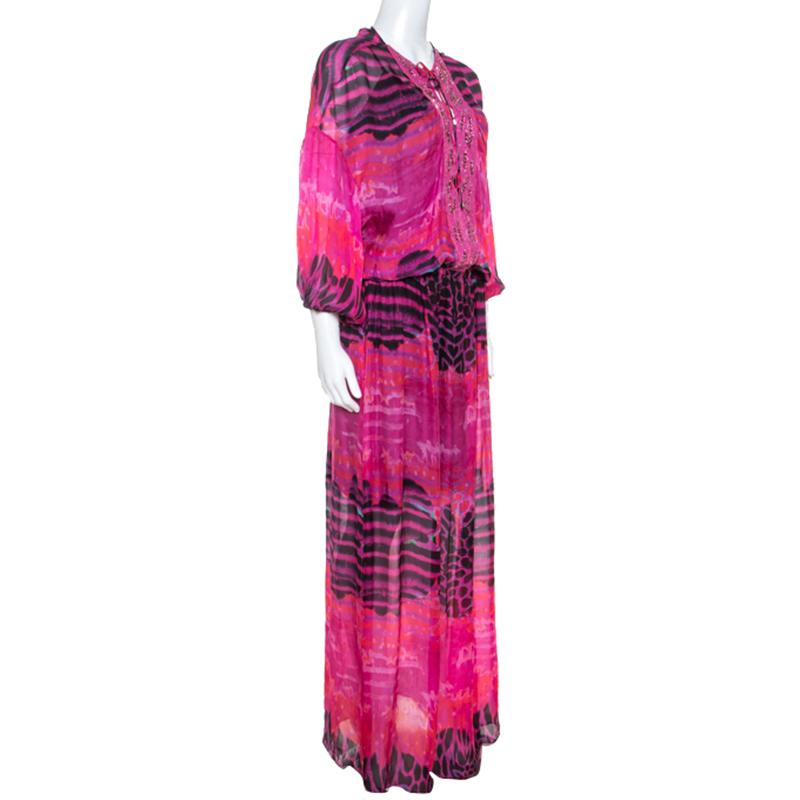 This striking maxi by Roberto Cavalli is perfect for a night out. Created from luxurious silk, it comes in a lovely shade of pink and features an interesting print. The neckline is embellished with sequins, beads and Swarovski crystals. With long
