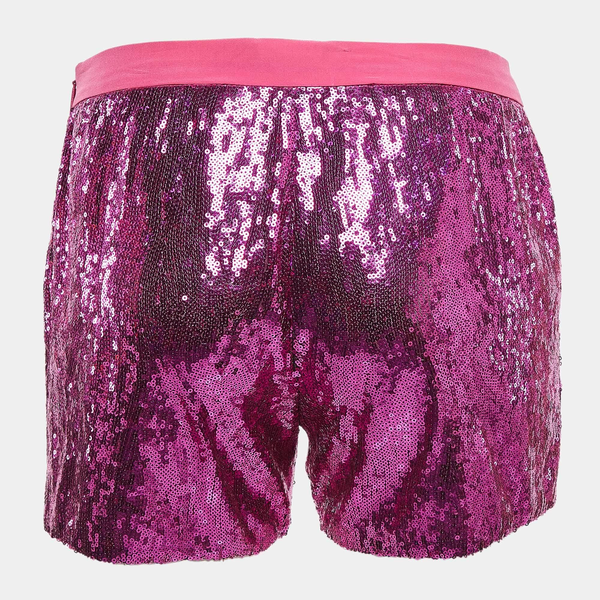 Roberto Cavallis pink sequin shorts shimmer with a playful yet refined aesthetic. Adorned with glistening sequins they capture light with every movement adding a touch of glamour to any outfit. Perfect for making a bold statement these shorts blend