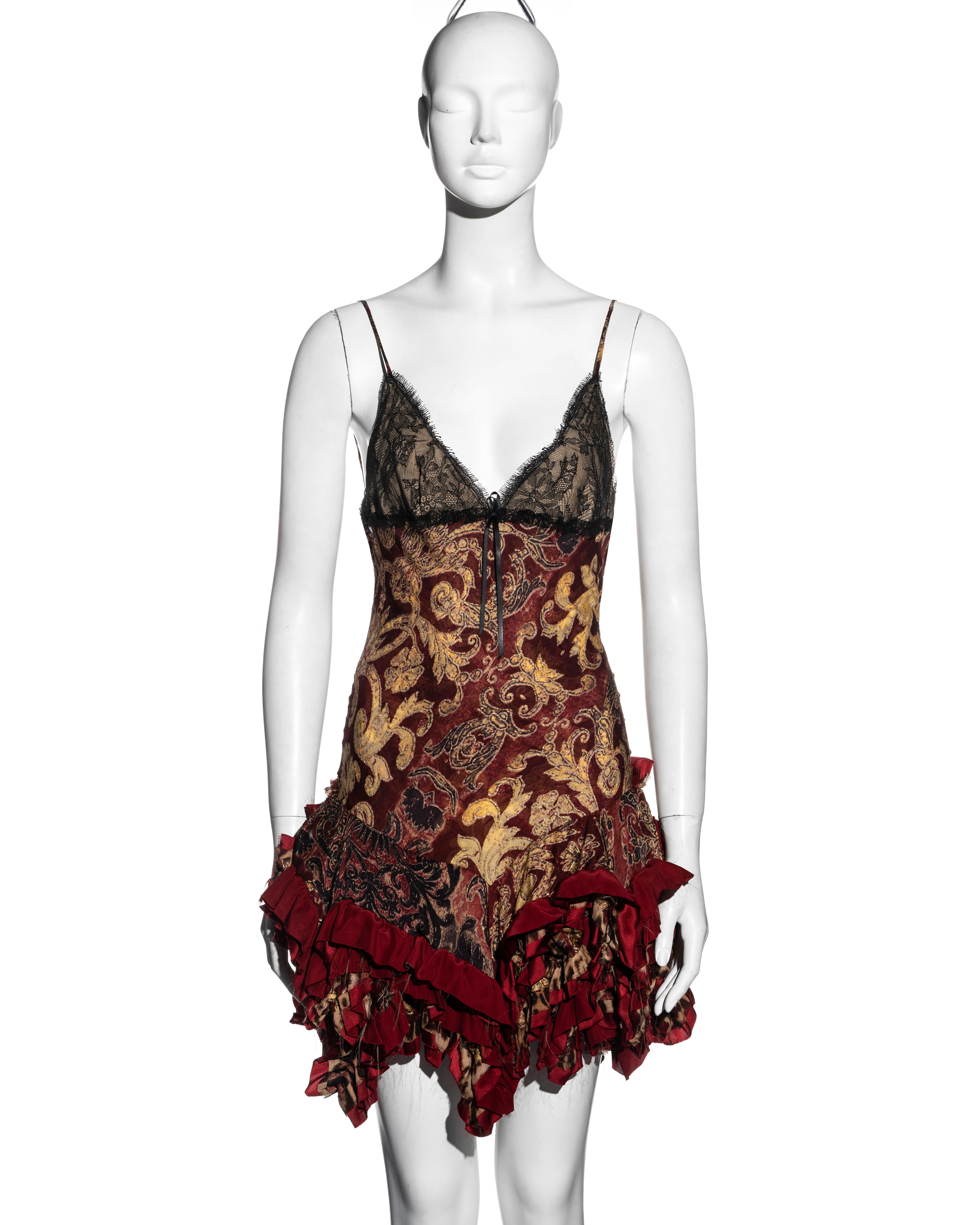 ▪ Roberto Cavalli evening slip dress 
▪ Red and gold brocade-print silk 
▪ Black lace overlay on the breasts with raw edges 
▪ Spaghetti straps 
▪ Silk ribbon bow detail 
▪ Full ruffled mini skirt with an asymmetric frayed hemline 
▪ Size Small
▪