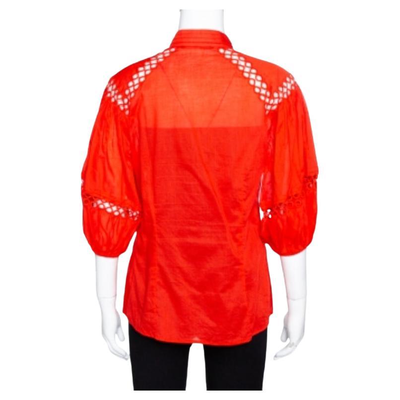 This Roberto Cavalli blouse is carefully crafted for a relaxing yet modish formal look. Made from cotton, it features a bright red shade along with an eyelet lace detail. This blouse will lend an urban feel remaining true to the label’s bold