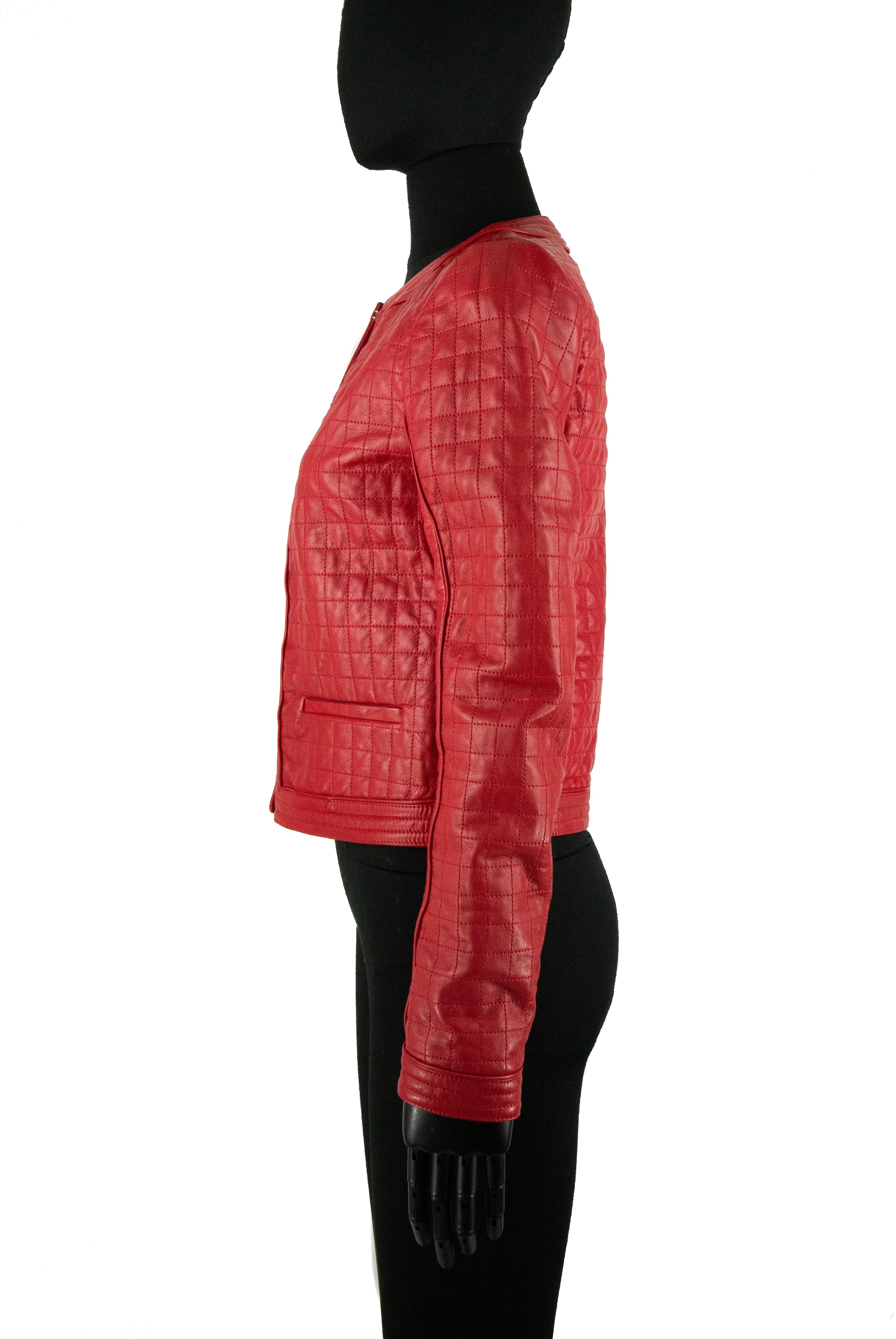 A red Roberto Cavalli leather jacket with a quilted topstitched effect. This piece has a piped trim that wraps around the collar and throughout the hem of the jacket and around the cuffs. It features shallow pockets at the front and hook and eye