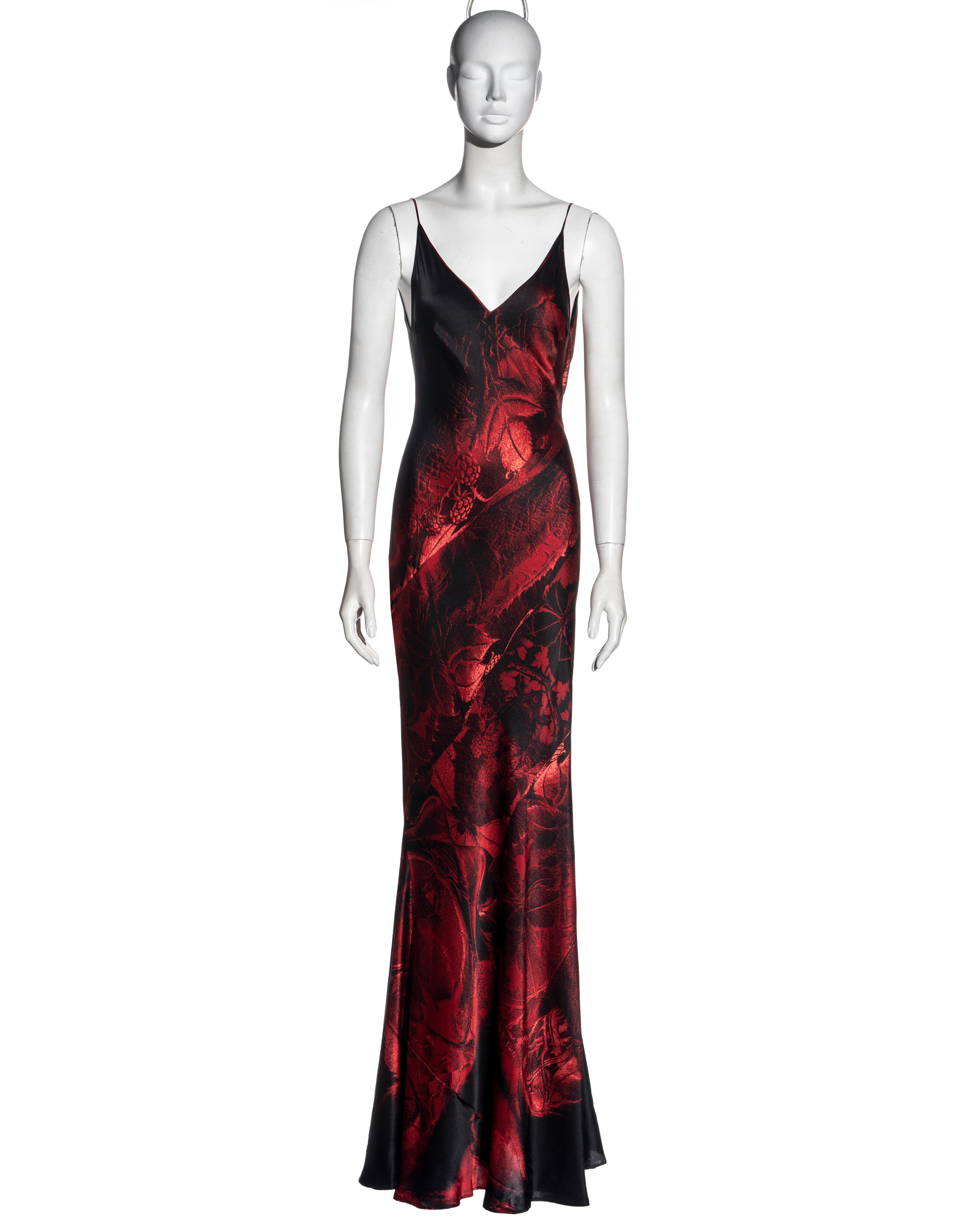 ▪ Roberto Cavalli red silk floor-length evening dress
▪ Red and black abstract photographic print 
▪ Bias-cut
▪ Low back with draped cowl 
▪ Floor-length skirt with train 
▪ Spaghetti straps 
▪ Size Large
▪ Fall-Winter 2000
▪ 100% Silk
▪ Made in