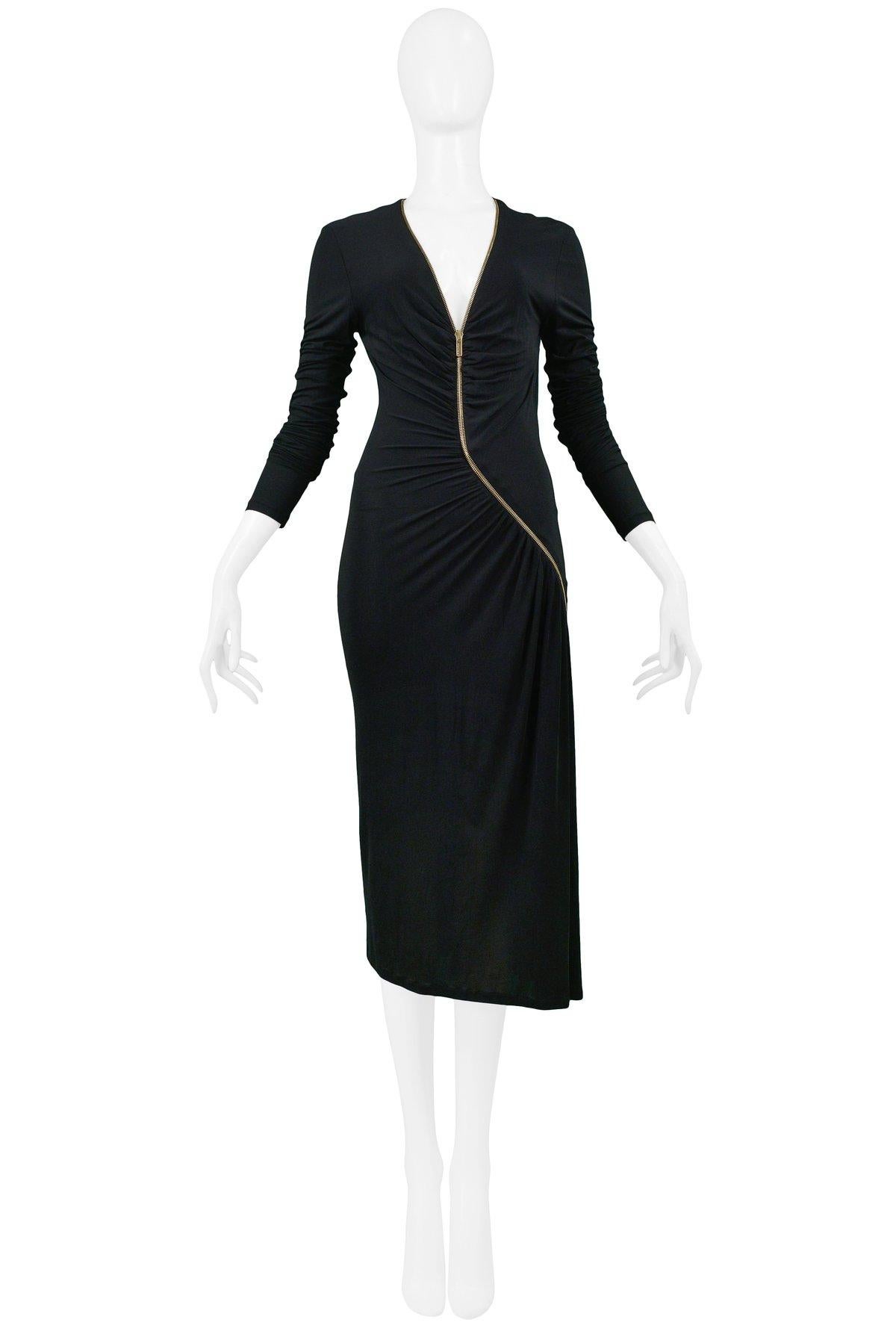 A stunning vintage Roberto Cavalli black embellished zipper dress. The dress features long sleeves, below the knee hemline, and an asymmetrical gold-tone zipper from neckline to rear hem with gathered detail.

Roberto Cavalli
Size Large
4% Elastane,