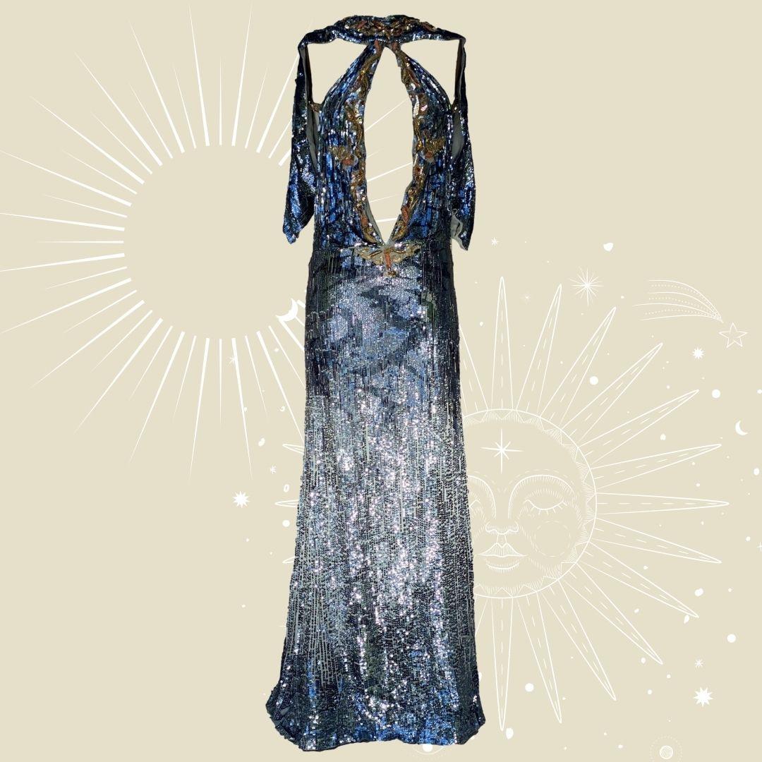 Roberto Cavalli - Sequin runway evening gown with Swarovski crystal embellished sun cape. Neckline presents a sharp daring plunge to the navel.  The back of the dress is held by jewel encrusted crisscross straps and finished with a sexy side split