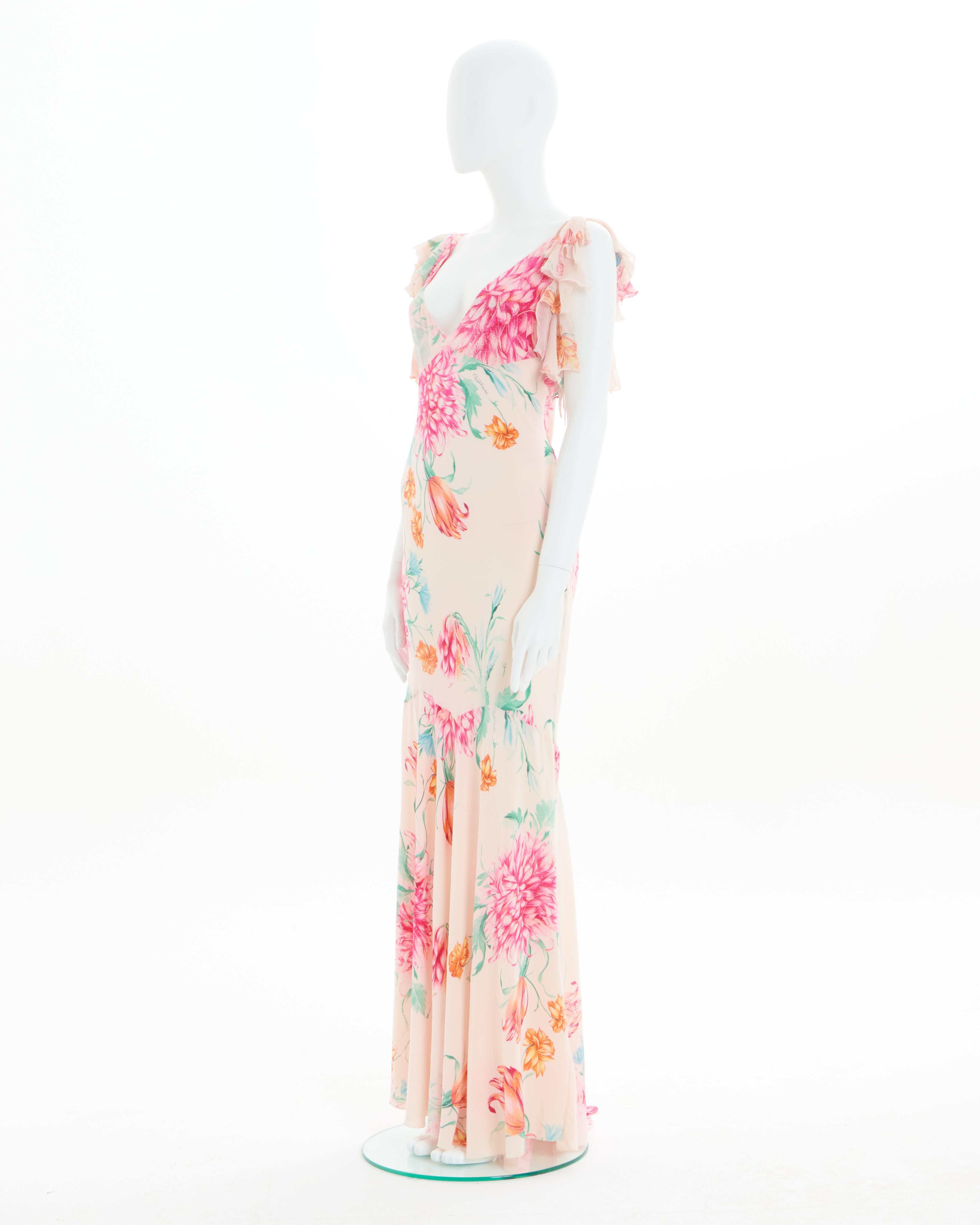 - Roberto Cavalli
- Sold by Skof.Archive
- Spring - Summer 2002 
- Luxurious light silk and features a vibrant floral pattern with pink and orange flowers complemented by hints of green leaves
- Frilled sleeves
- Crafted from luxurious bias-cut
