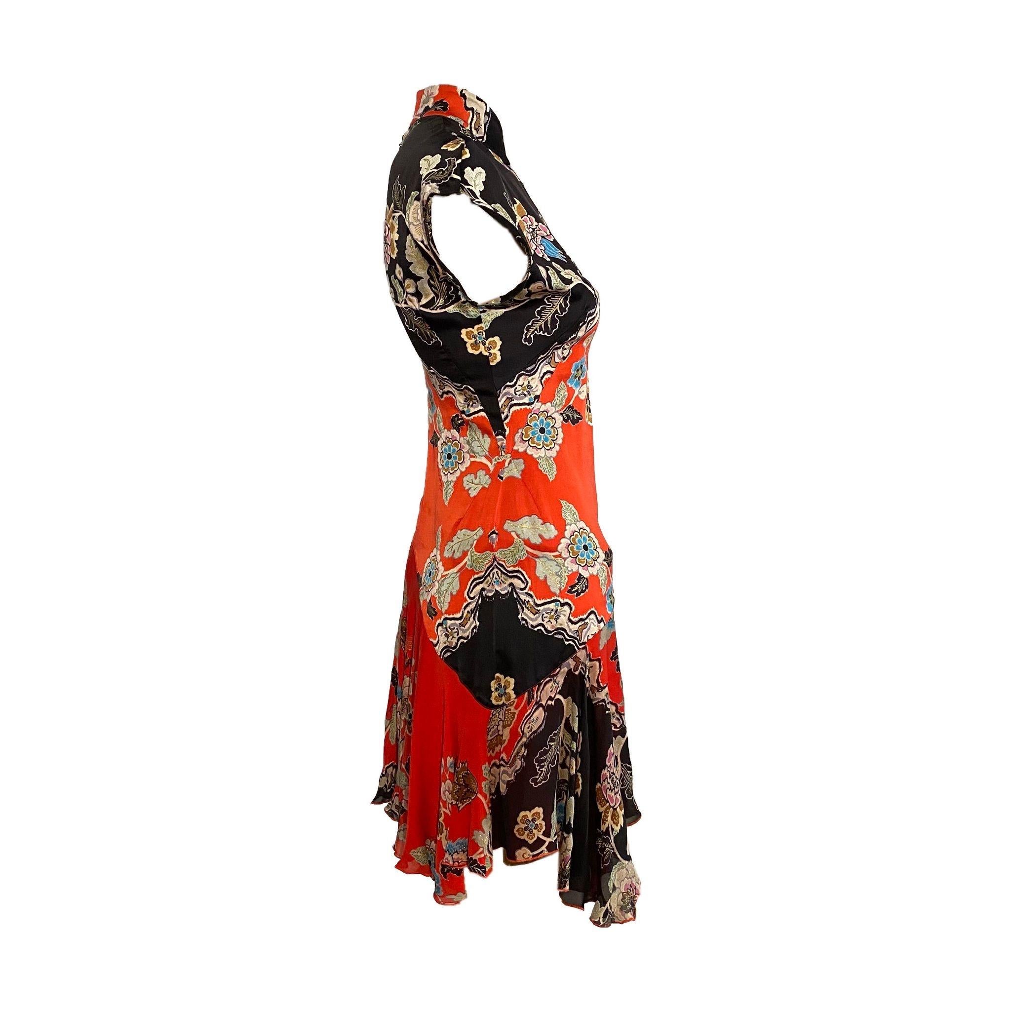 Roberto Cavalli Cheongsam-inspired Mini Dress with Front Slit from the Spring/Summer 2003 collection, similar version seen on Esther Cañadas on final look. Vibrant oriental print in red and black, bias cut.

Size S, 100% Silk

Measurements:

Bust -