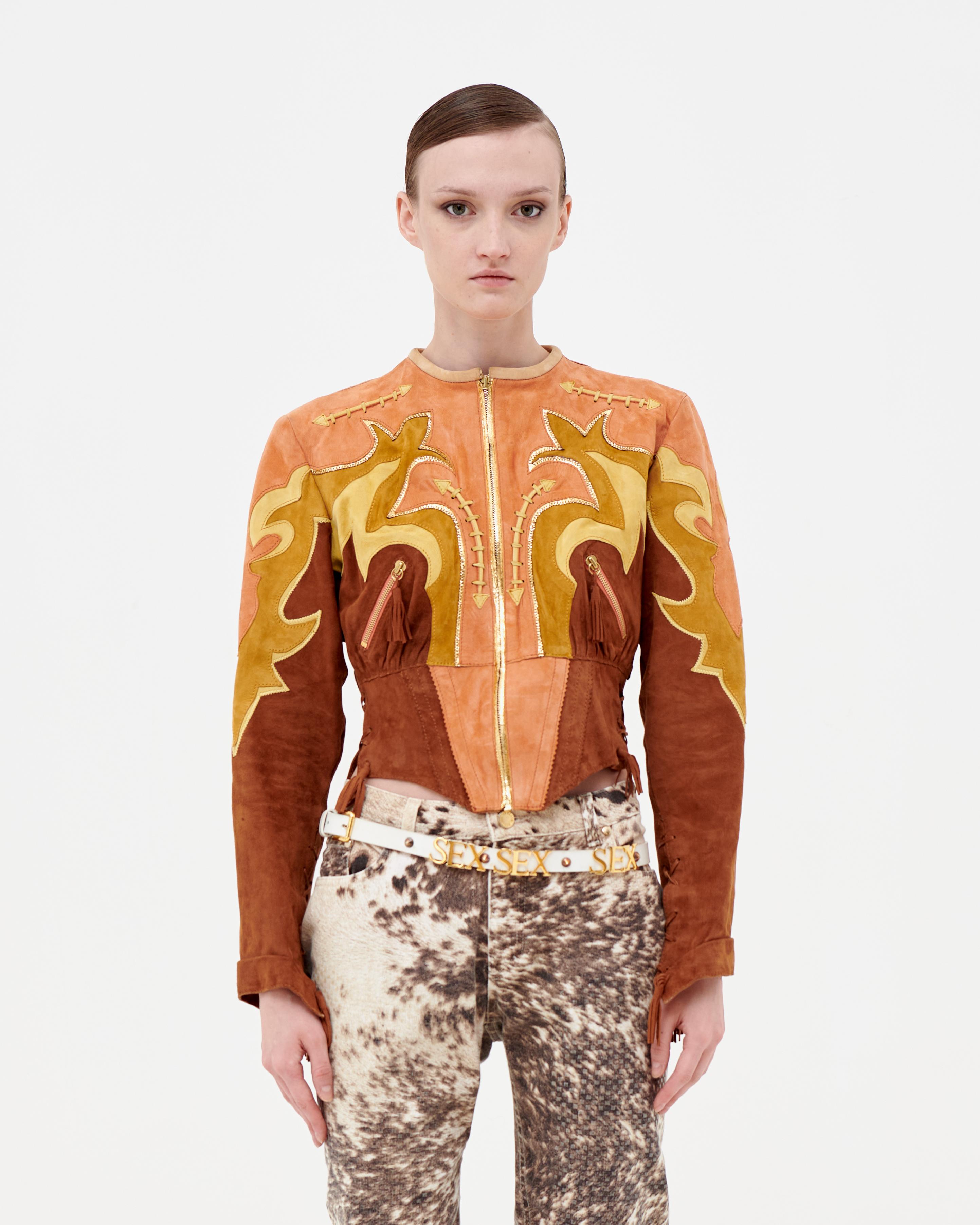 Roberto Cavalli 70s-inspired Western crop leather jacket in soft hand-cut Deer skin and suede. Corset style, metallic gold leather accents, lace-up details on both sleeves and sides.

Runway piece from Spring/Summer 2004, worn by Marianna Weickett