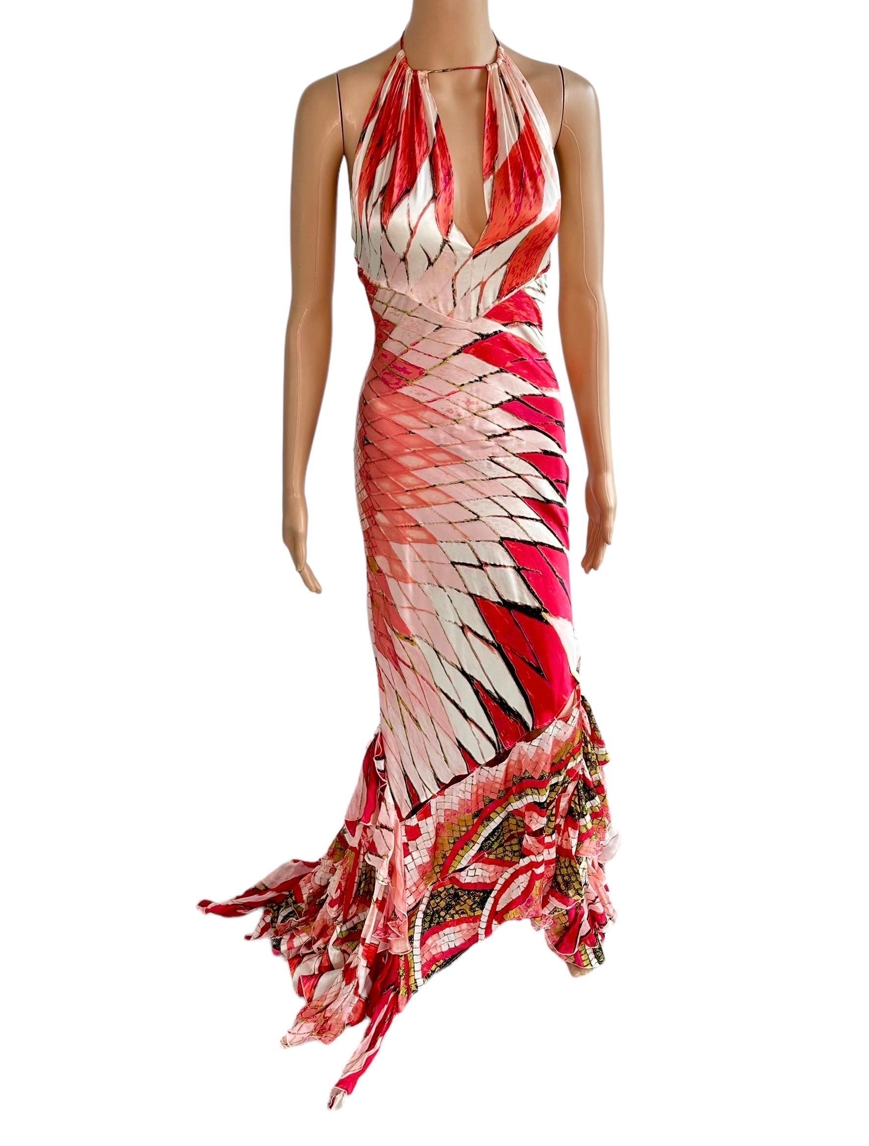 Roberto Cavalli S/S 2004 Plunging Neckline Cutout Detail Ruffles Train Silk Evening Dress Gown

Roberto Cavalli stained glass print silk halter evening gown featuring plunging neckline with keyhole accent, low open back and fishtail asymmetrical