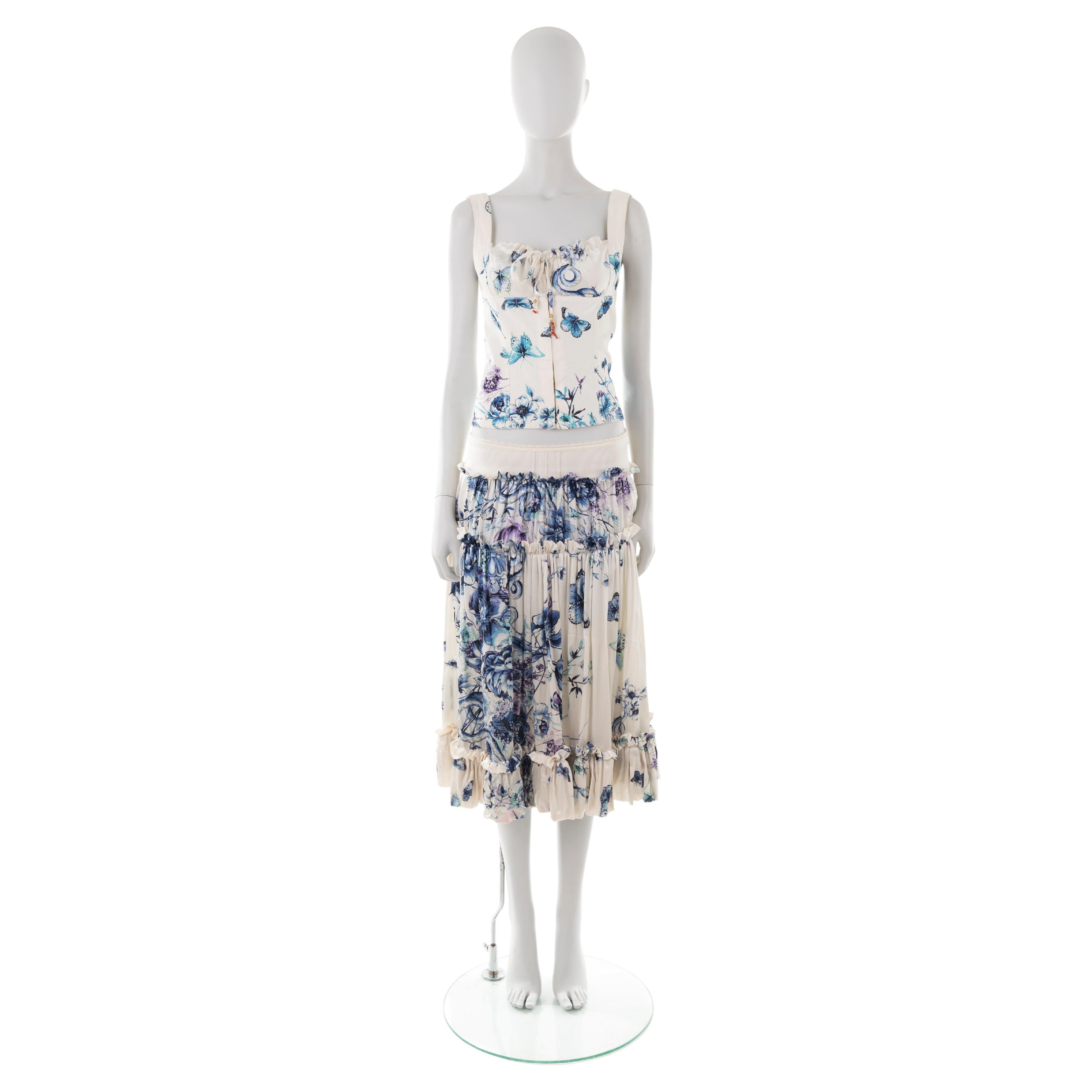 - White siilk set (top + skirt)
- Purple/white butterfly floral print
- Cotton denim corset-inspired structured top
- Silk collar with drawstring (coral charm attached)
- Low waist multi-panel silk boho skirt