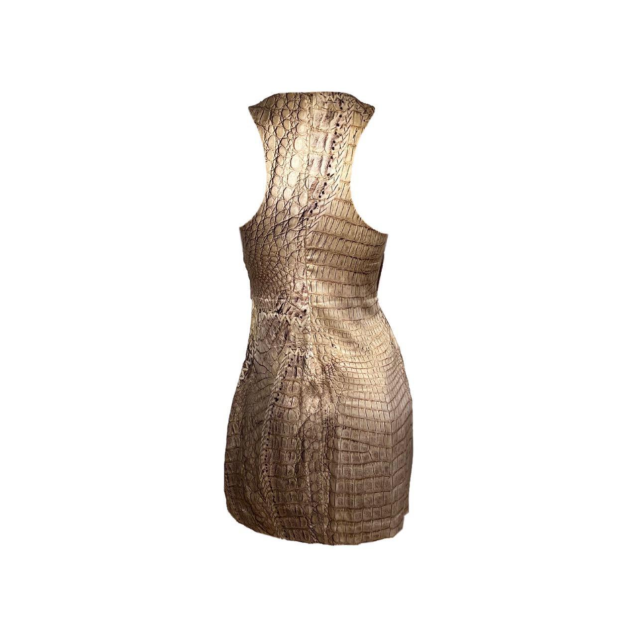 Roberto Cavalli Tan Silk short dress from the S/S 2011 collection, which marks the 40th anniversary of the designer. The dress has a lace-up front top matched by a sequence of side gradient fringes. Zip closure system on the back.

Size IT 42

Pit
