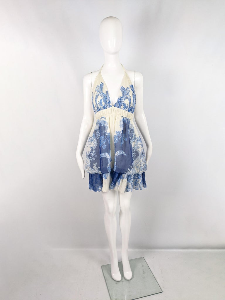 A fabulous archival Roberto Cavalli dress from the Spring Summer 2007 collection. In a cream silk with a blue feminine print, a halter neck that ties around the back of the neck, a puffball / bubble effect over the top of the skirt and a sexy plunge
