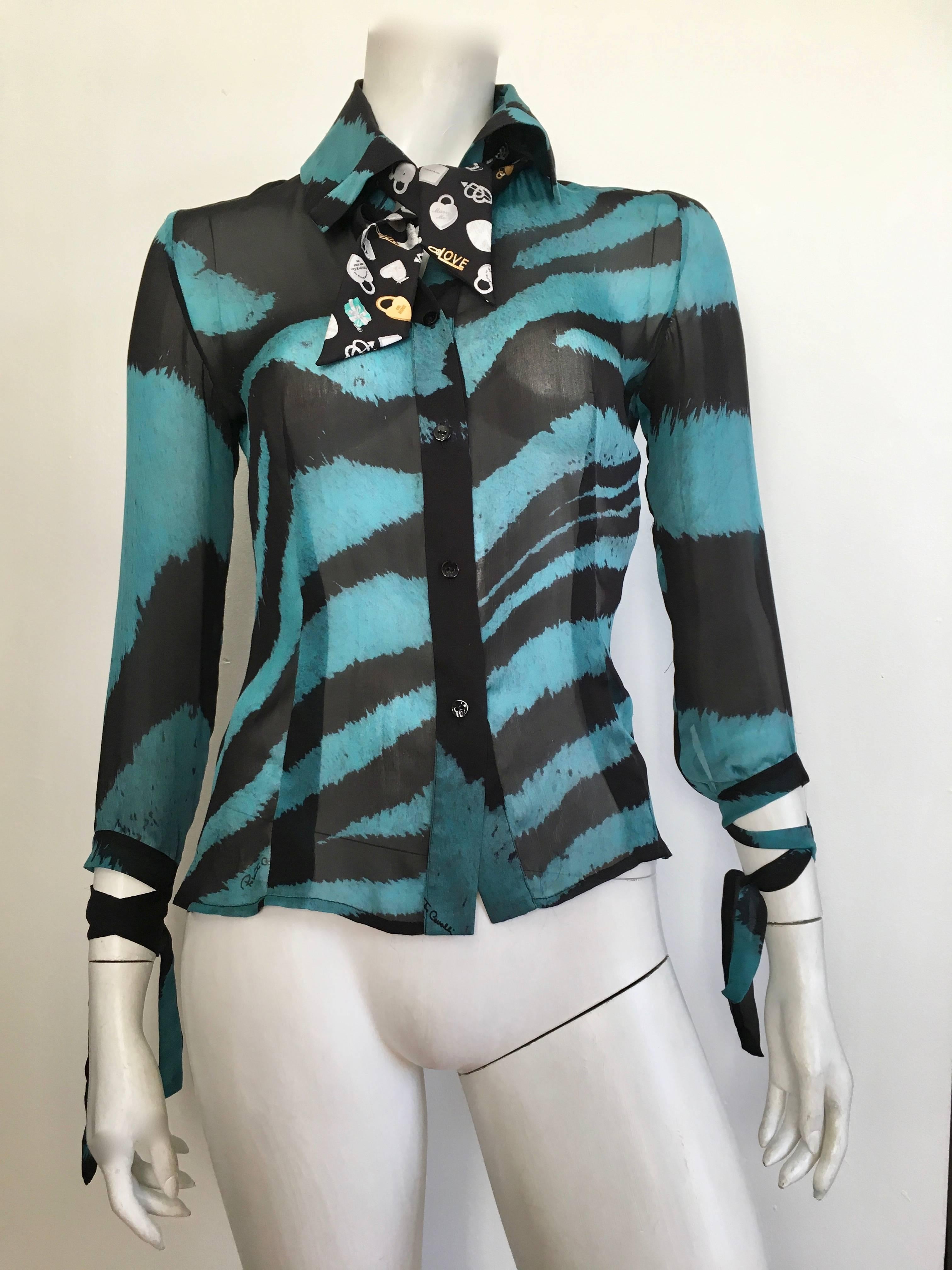 Roberto Cavalli black & teal silk animal print pattern with bondage ties sleeves is a size x-small.  This fit Matilda the Mannequin which is a size 4 but I recommend a size 0 or 2 for this blouse. Gorgeous and timeless design this silk blouse is the