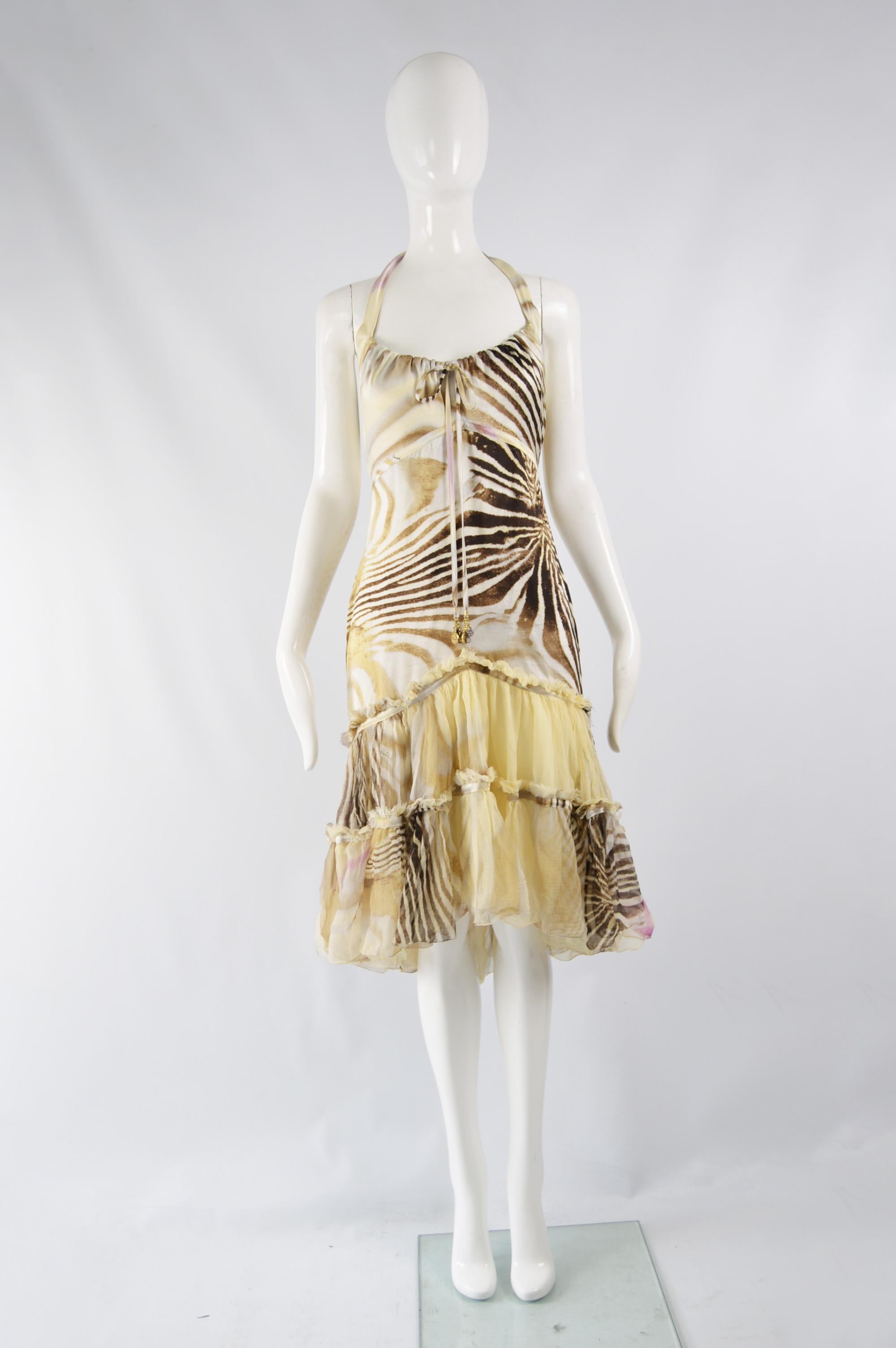 A stunning Roberto Cavalli dress in an animal printed silk satin with a tiered silk chiffon skirt. It ties at the back of the neck with a halter neck. Perfect for the day or evening. 

Size: Marked M but better fits a UK 10/ US 6/ EU 38. Please