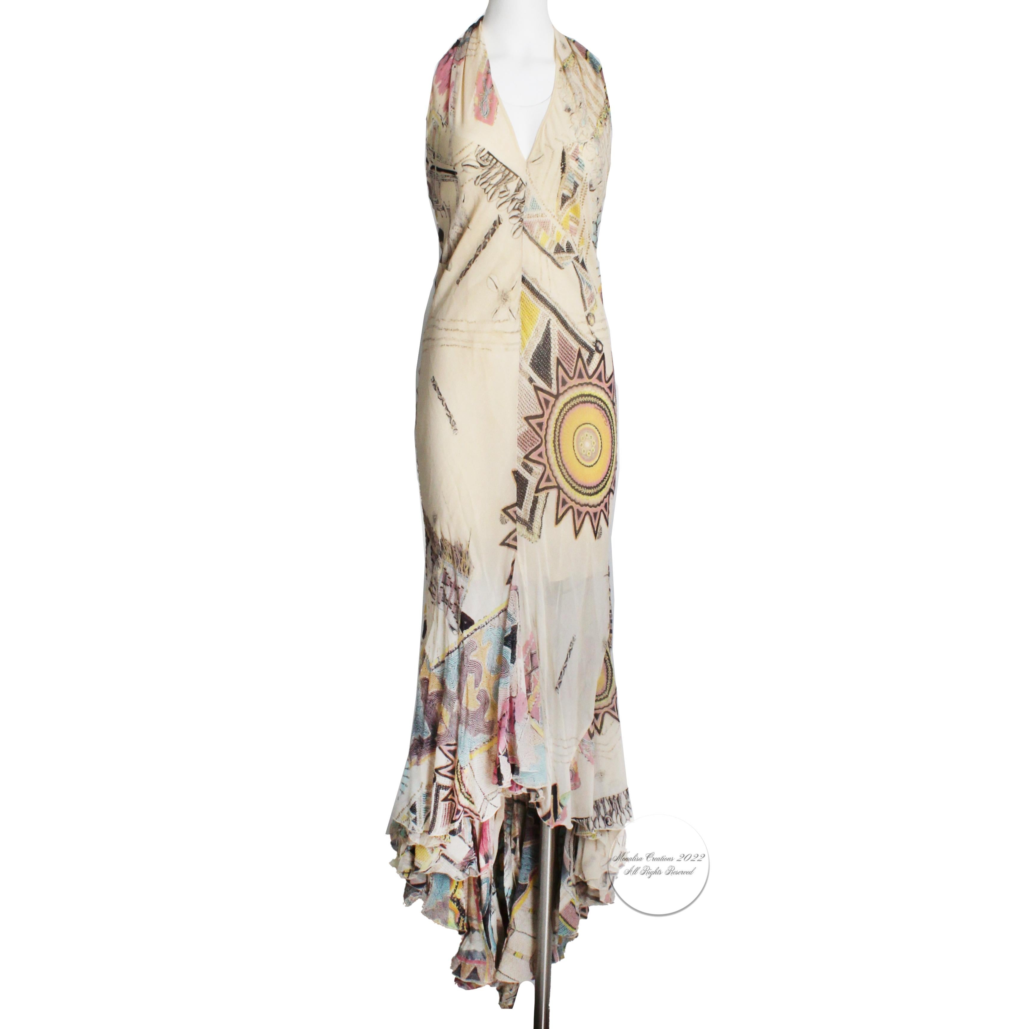 This lovely silk chiffon halter dress was made by Roberto Cavalli and previously owned by Serena Williams.  It features an abstract print with sunburst motif against a creme colored background and is partially lined to the mid-thigh.  The godet