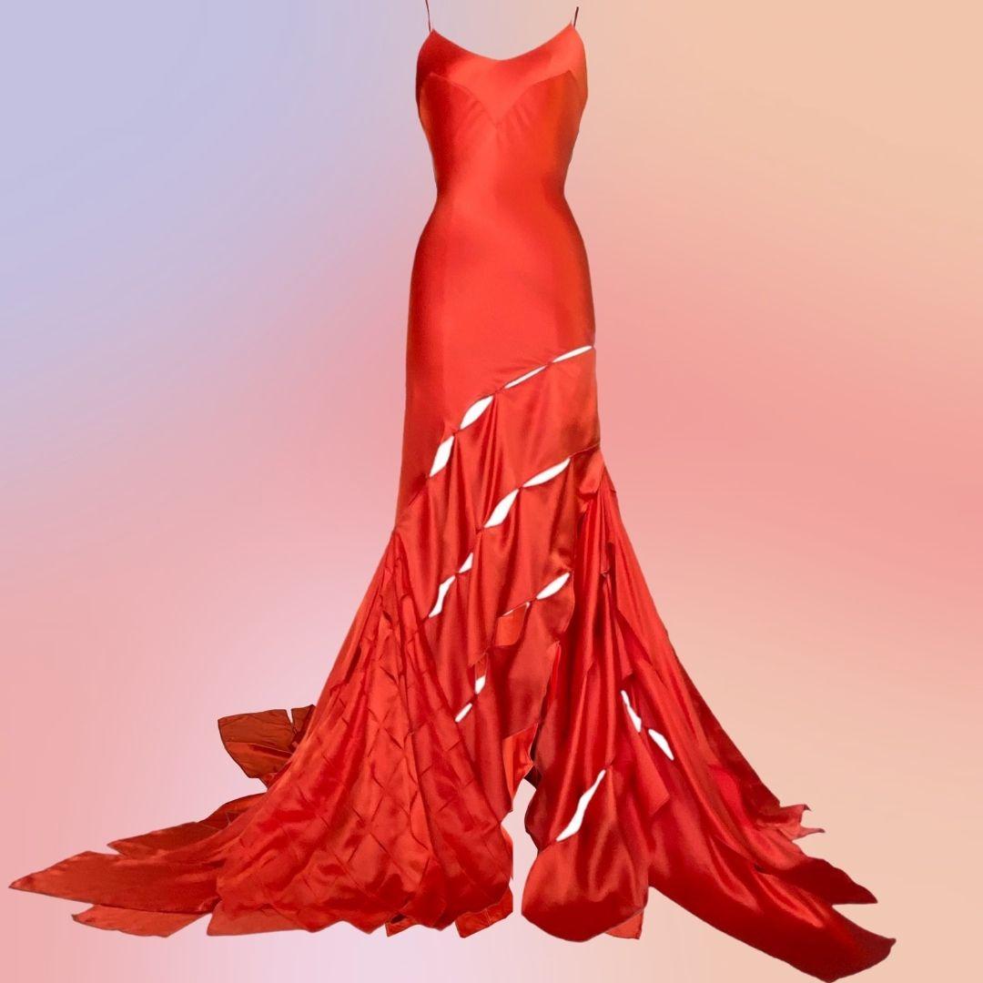 Roberto Cavalli - This silky orange evening gown is just like the one famously worn by Cindy Crawford in the Harper's Bazaar Roberto Cavalli Spring 2004 Editorial.  Beautifully constructed with strips of silk and geometric angles make up the