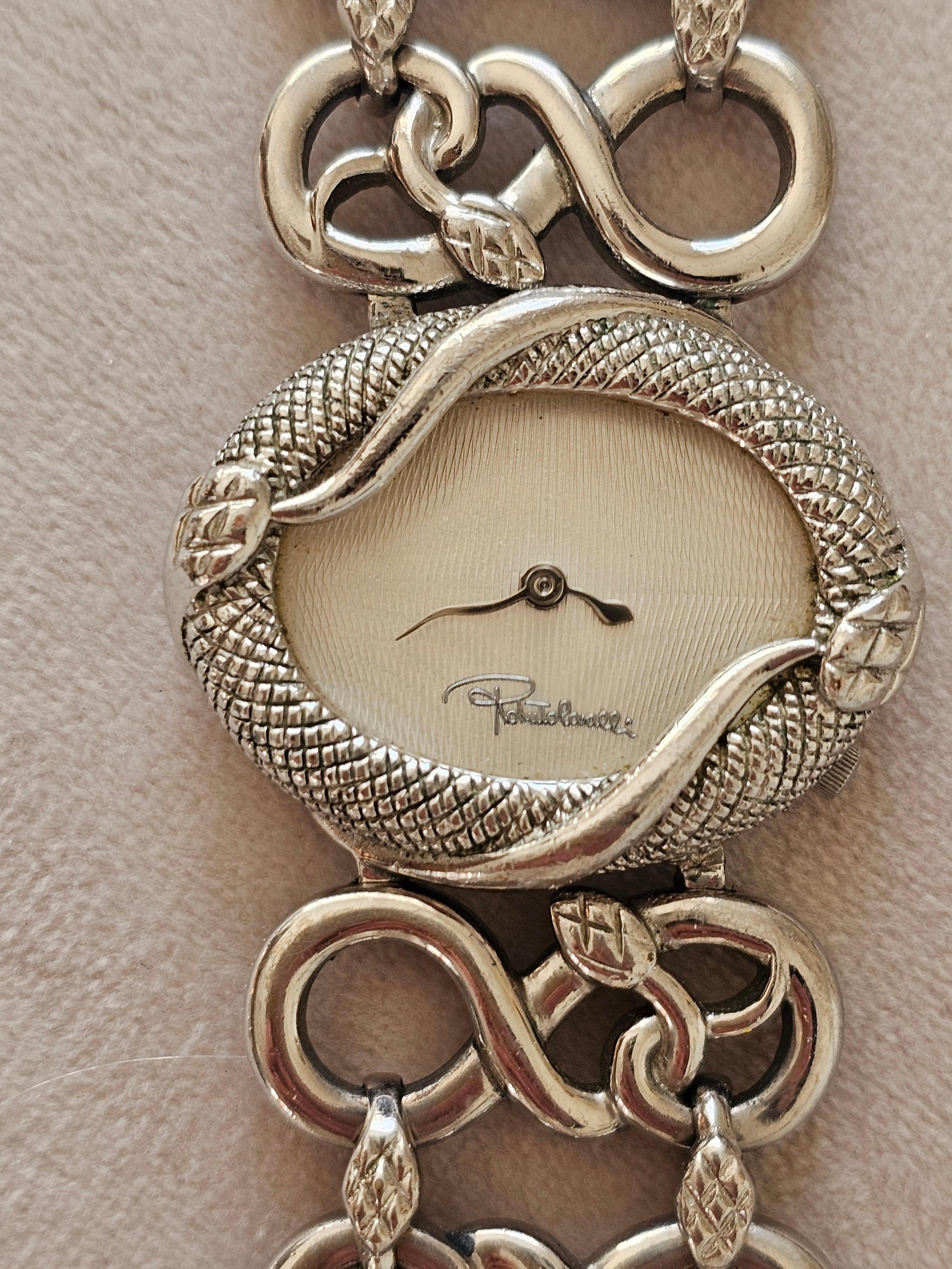 Very rare and exceptional Vintage Roberto Cavalli Wrist Watch Snakes. Step into the world of bold elegance with this Roberto Cavalli timepiece, designed for those who stay young in spirit, no matter their age. Inspired by the wild beauty of the