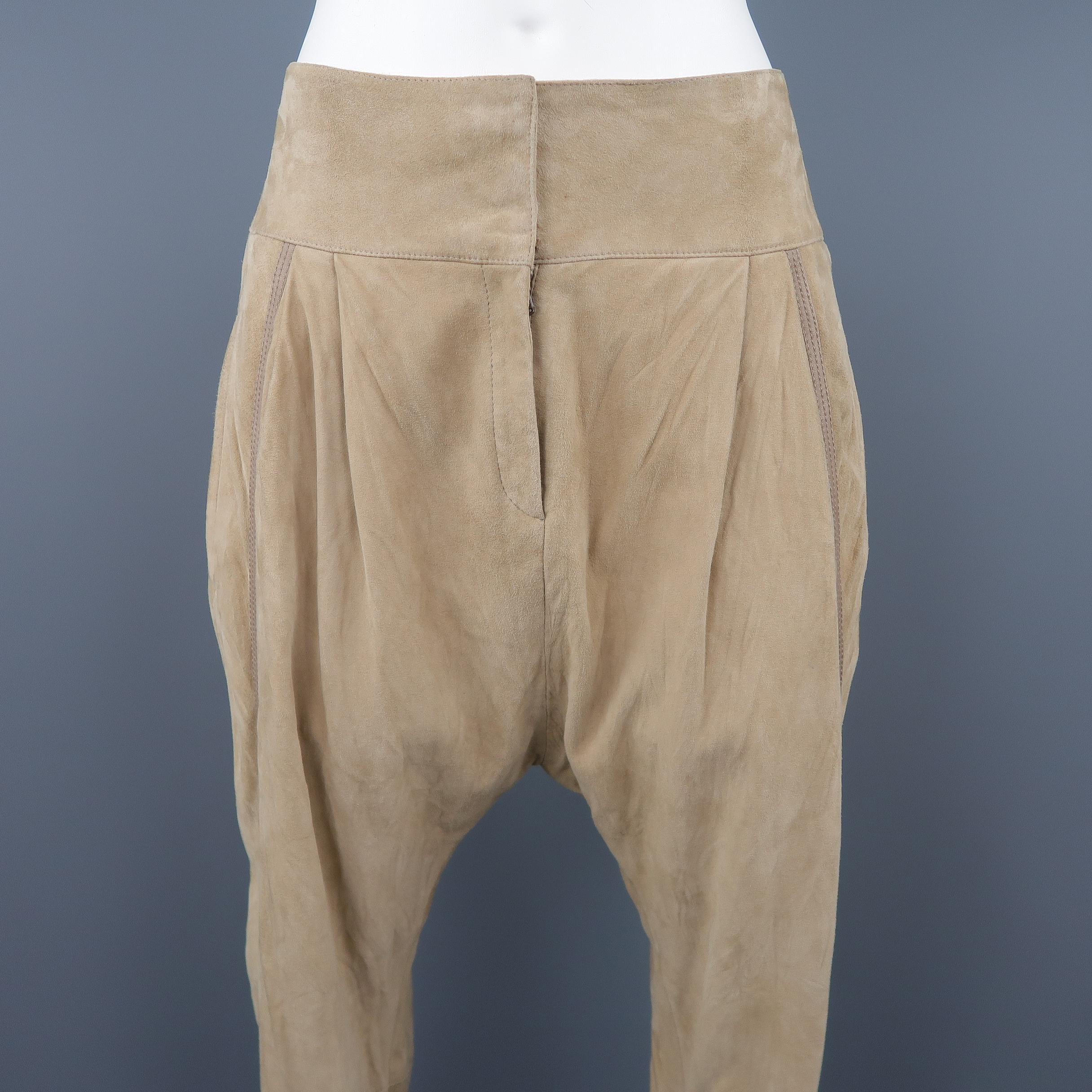 ROBERTO CAVALLI drop crotch pants come in beige suede with a thick waistband, pleated front, slit pockets, taupe leather trim, and skinny leg. Made in Italy.
 
Excellent Pre-Owned Condition.
Marked: IT 44
 
Measurements:
 
Waist: 33 in.
Hip: 42
