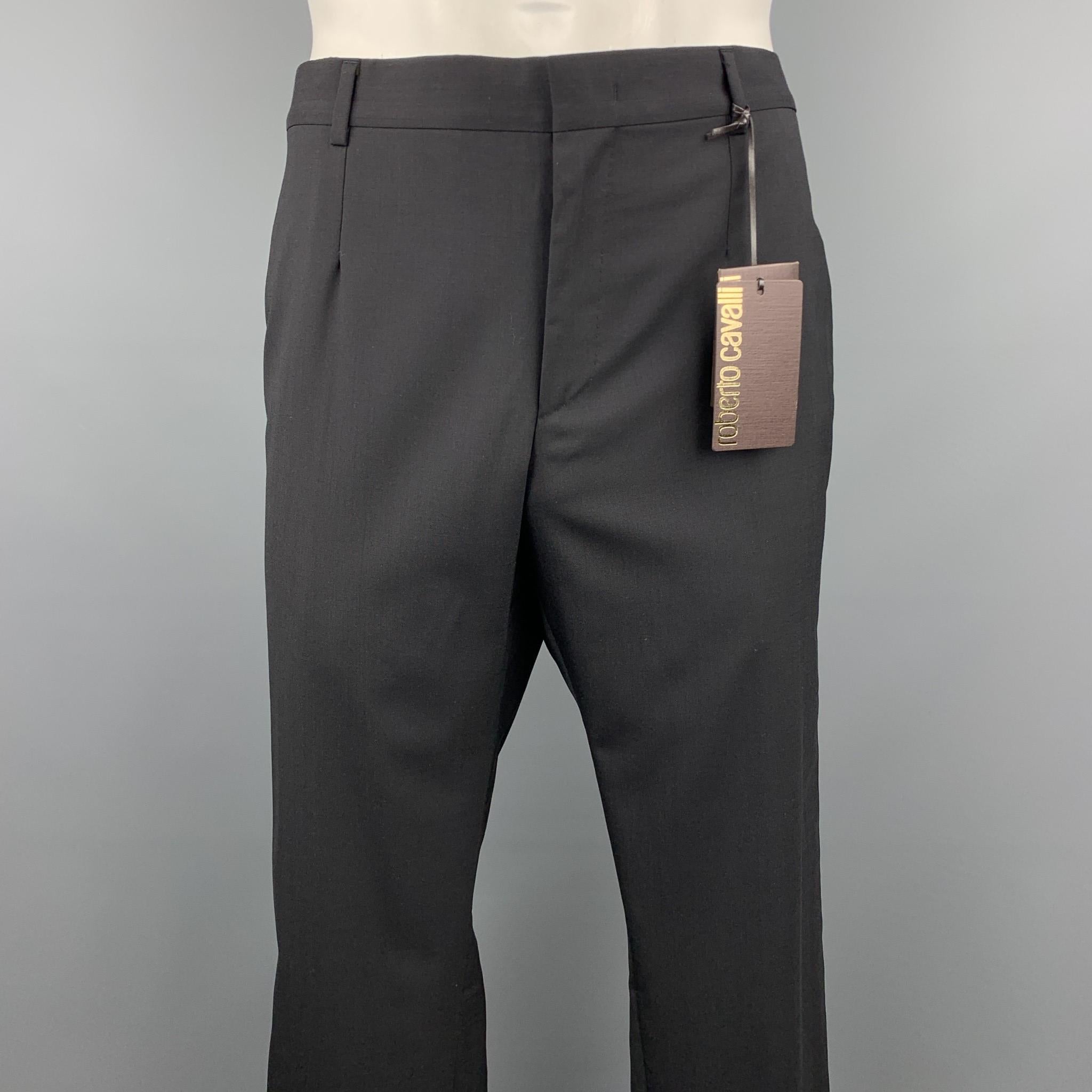ROBERTO CAVALLI tuxedo dress pants comes in a black wool / elastane featuring a front pleat, metallic trim, and a zip fly closure. Made in Italy.

New With Tags. 
Marked: IT 54

Measurements:

Waist: 40 in.
Rise: 9.5 in. 
Inseam: 37 in. 