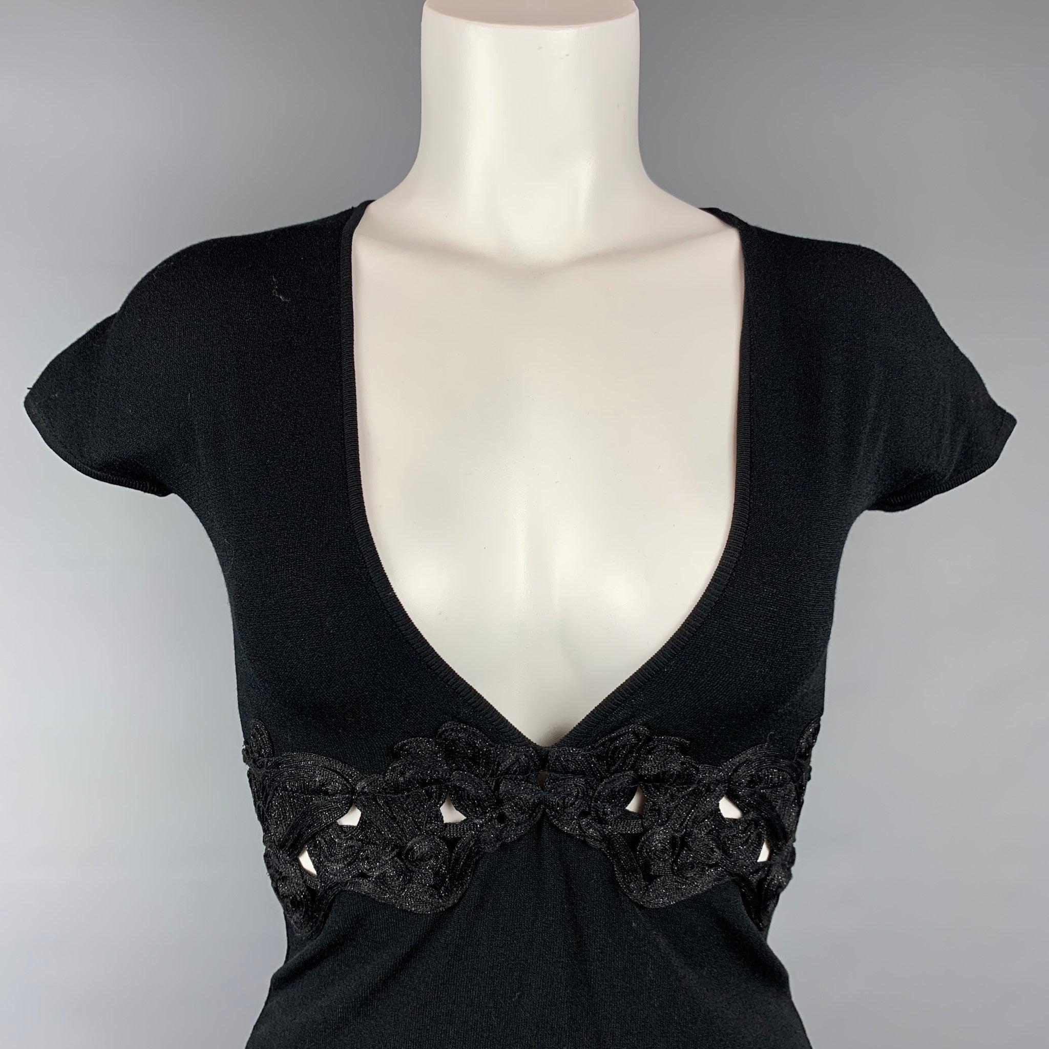 ROBERTO CAVALLI dress top comes in a black jersey viscose / polyester featuring a glitter cut out design, embellished rhinestone detail, and a v-neck. Made in Italy.Very Good Pre-Owned Condition. Minor wear on back.  

Marked:   40 

Measurements: 
