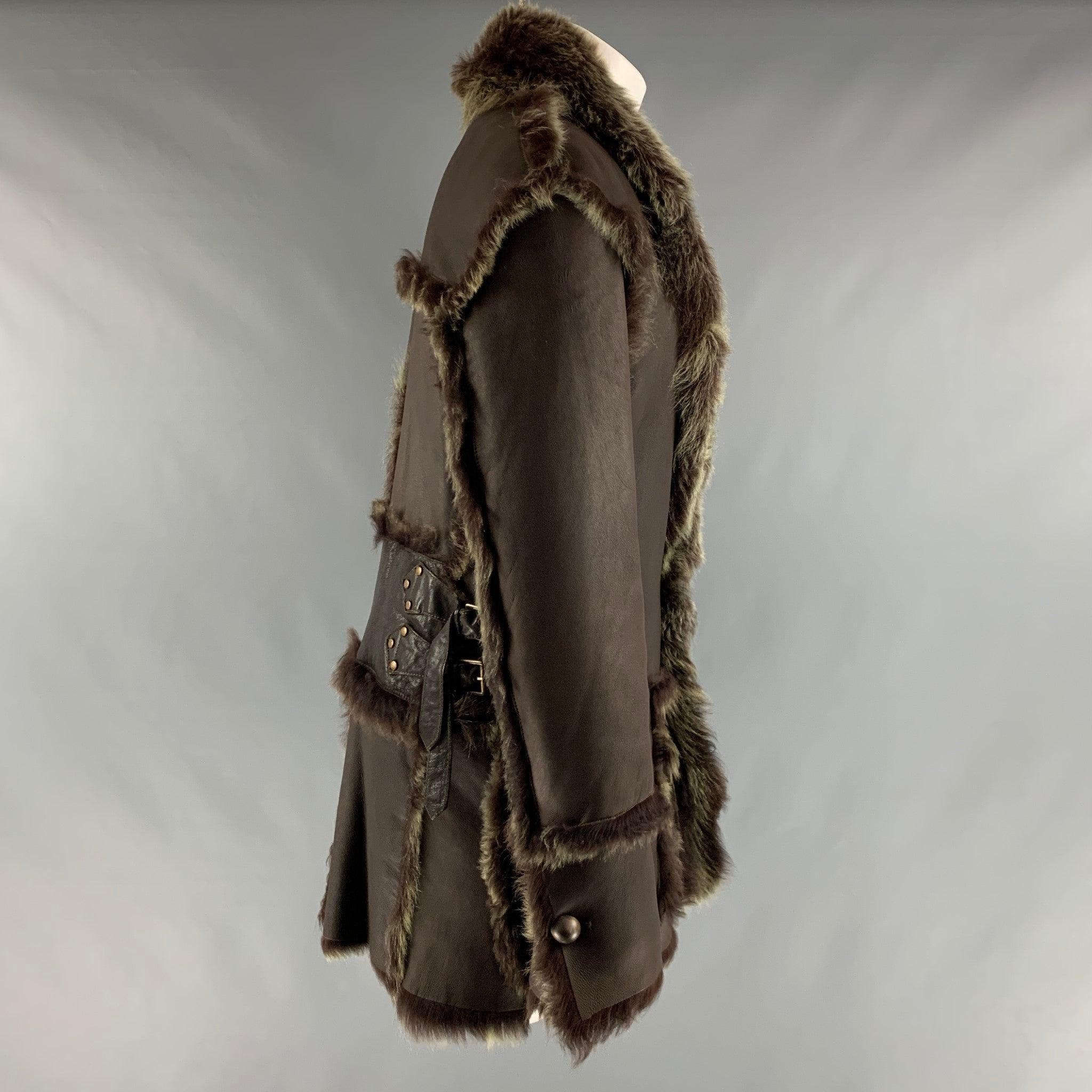 ROBERTO CAVALLI coat comes in a brown leather material featuring a faux fur lining, patch pockets, side buckle details, and a two button closure. Made in Italy.Excellent Pre-Owned Condition. 

Marked:  40 

Measurements: 
 
Shoulder: 20 inches
