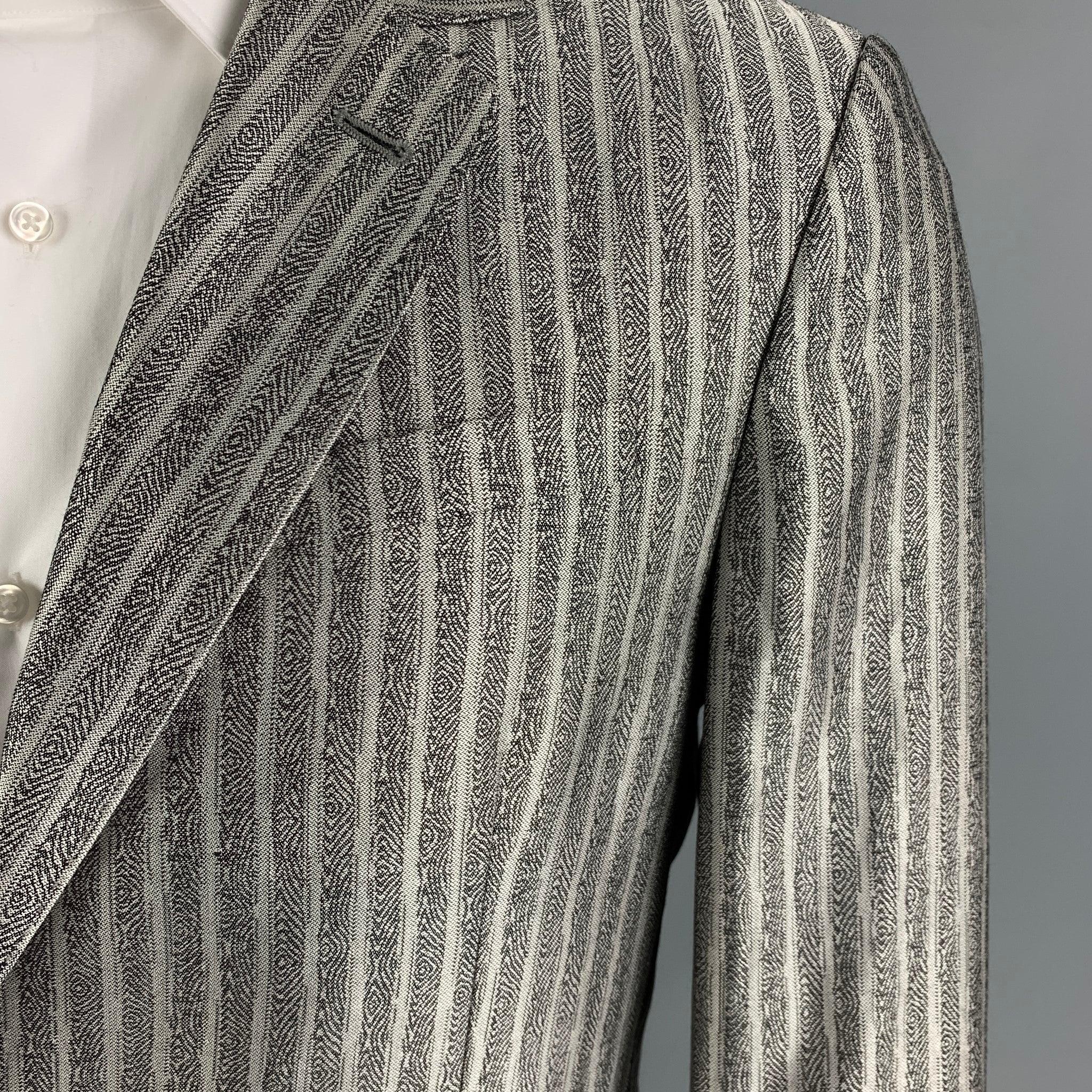ROBERTO CAVALLI spot coat comes in a silver & black wool / silk with a full liner featuring a notch lapel, flap pockets, single back vent, and a double button closure. Made in Italy.
New With Tags. 

Marked:   50 

Measurements: 
 
Shoulder: 18