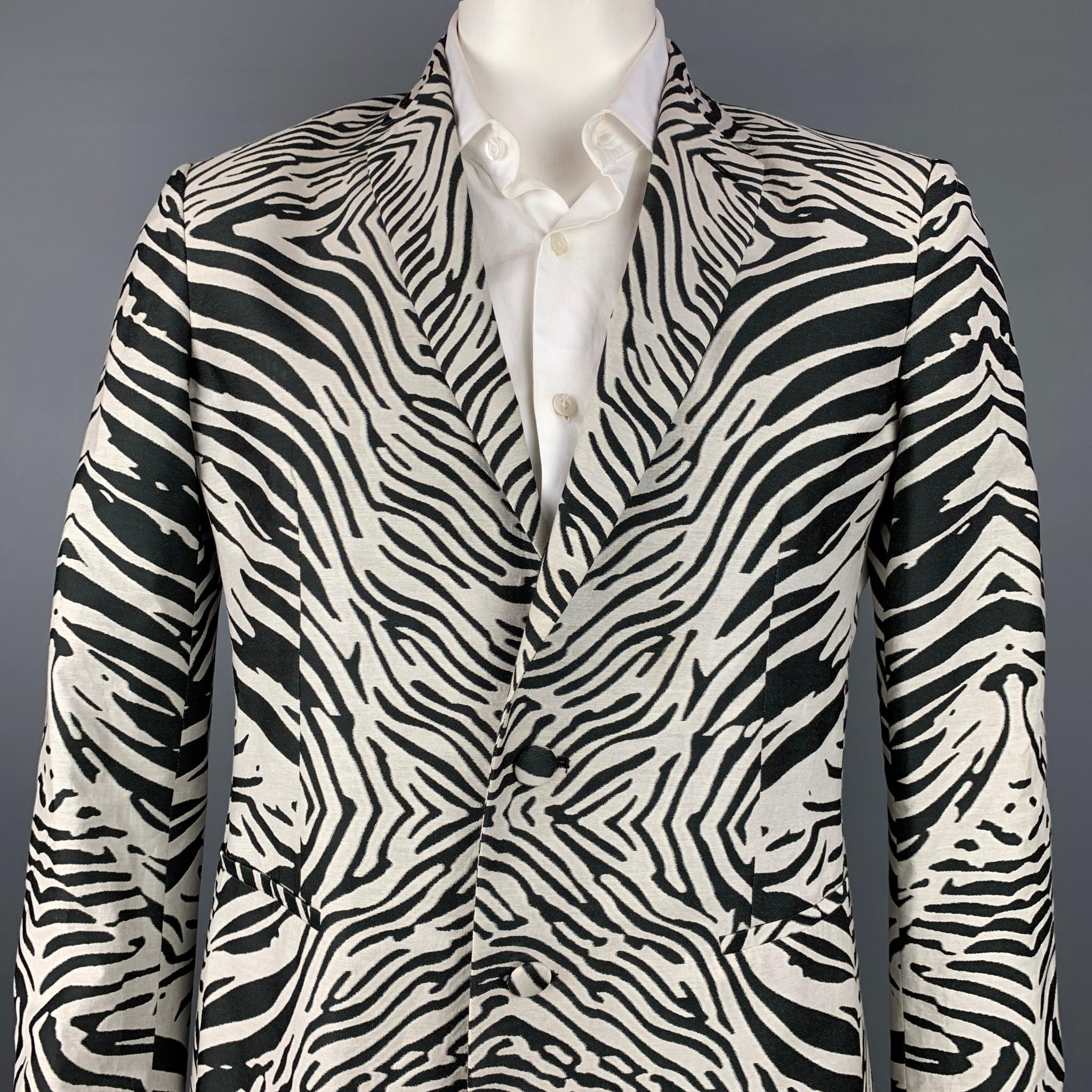 ROBERTO CAVALLI sport coat comes in a black & white zebra print polyester with a full liner featuring a notch lapel, slit pockets, and a two button closure. Made in Italy.

Very Good Pre-Owned Condition.
Marked: IT 52

Measurements:

Shoulder: 18.5