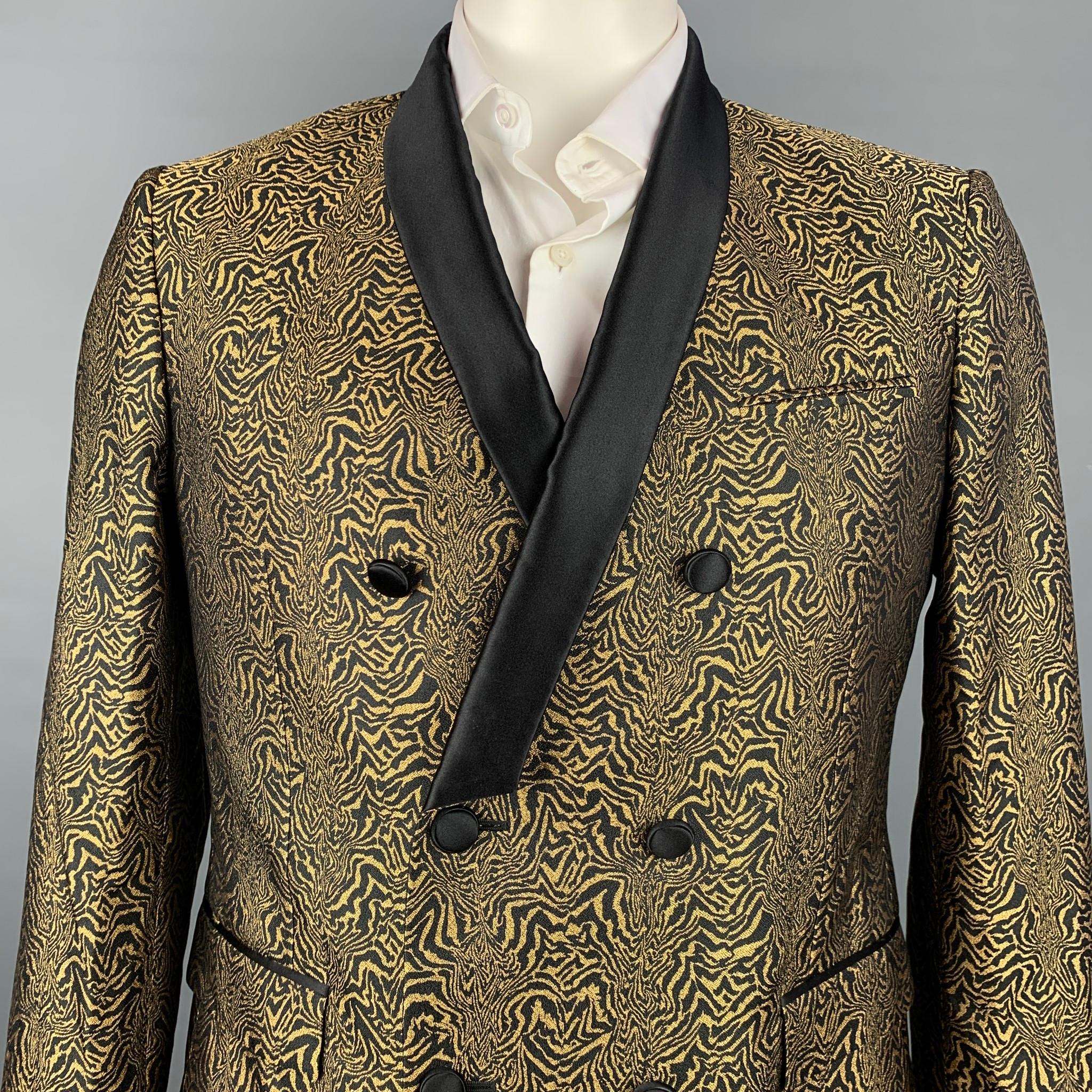ROBERTO CAVALLI sport coat comes in a black & gold jacquard silk with a full liner featuring a shawl collar, flap pockets, and a double breasted closure. Made in Italy.

New With Tags.
Marked: IT 54

Measurements:

Shoulder: 18 in.
Chest: 42