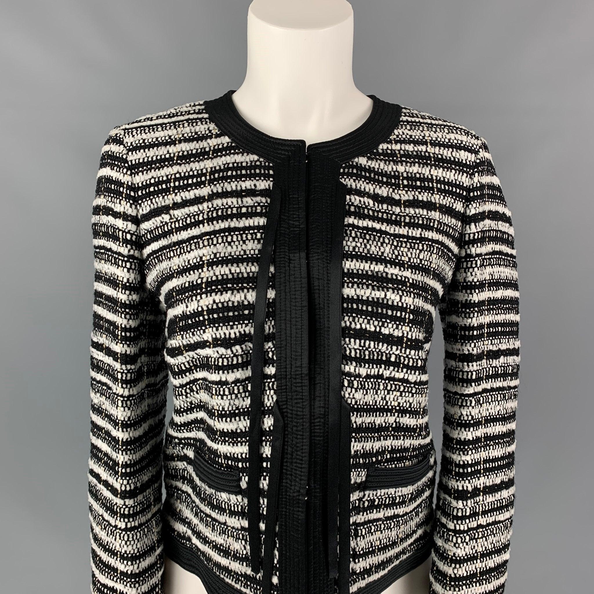 ROBERTO CAVALLI jacket comes in a black & white stripe textured boucle wool with a full liner blend featuring a collarless style, zipper sleeves, strap details, slit pockets, and a hook & loop closure. Made in Italy.New With Tags.
 

Marked:  