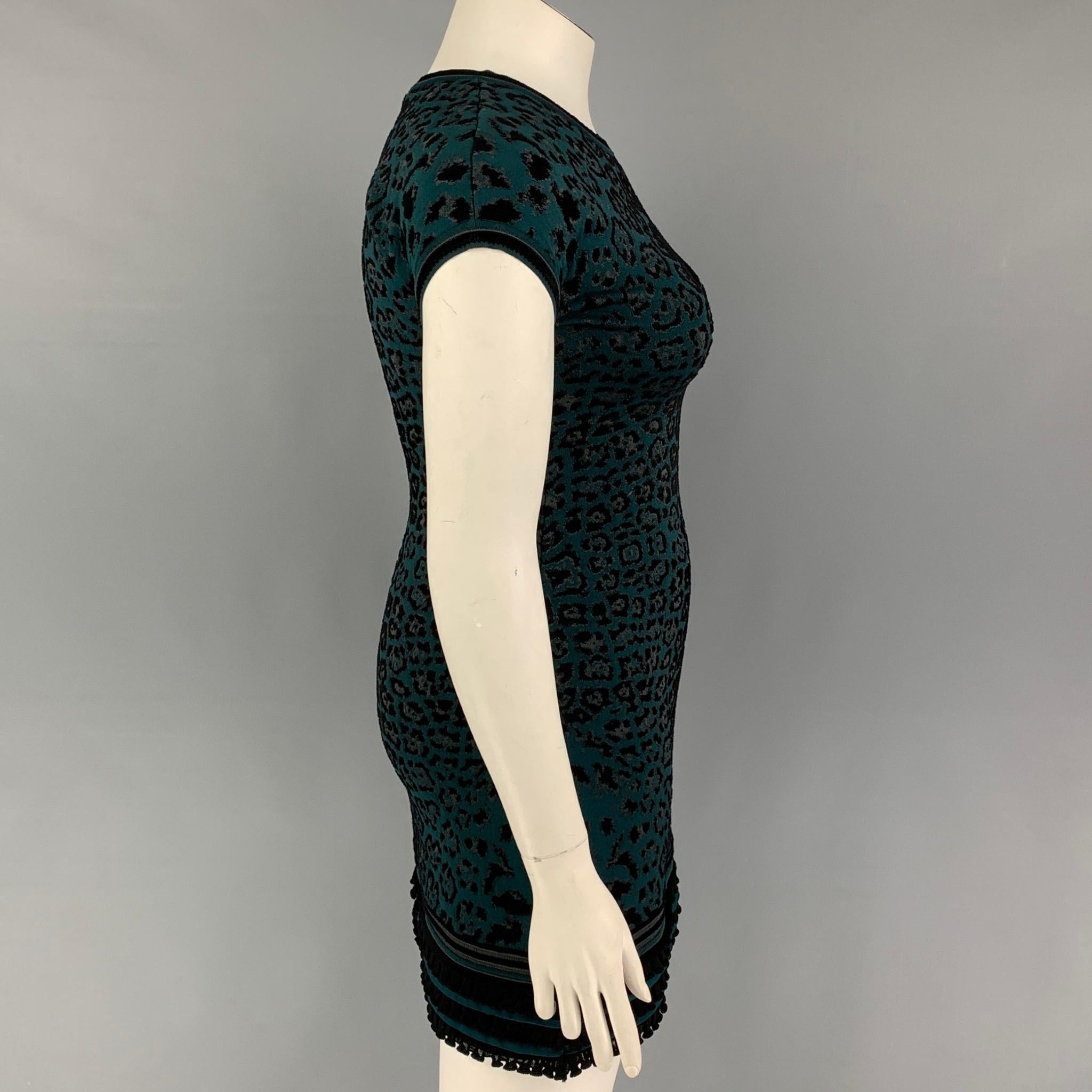 ROBERTO CAVALLI dress comes in a black & green animal print viscose blend featuring a a-line style, slim fit, ruffled hem, and cap sleeves. Made in Italy. 

Very Good Pre-Owned Condition.
Marked: 44

Measurements:

Shoulder:
Bust: 34 in.
Waist: 27
