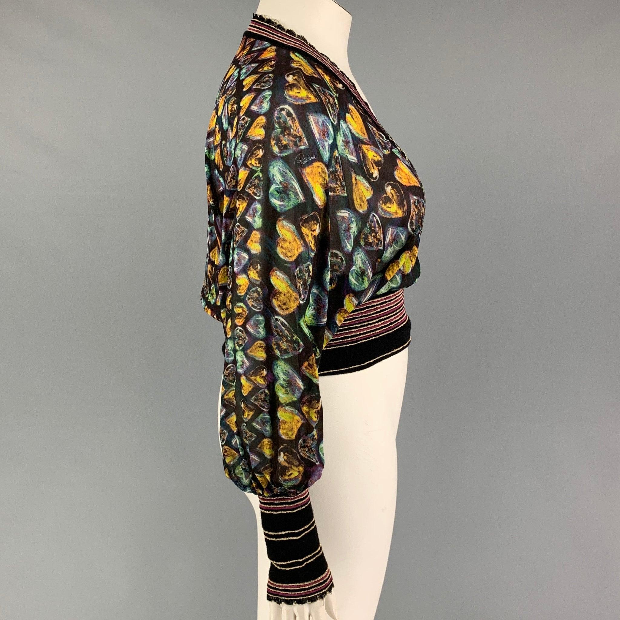 ROBERTO CAVALLI top comes in a multi-color heart print silk blend featuring a metallic stripe elastic hem design and a v-neck.
Very Good
Pre-Owned Condition. 

Marked:   44 

Measurements: 
 
Shoulder: 16 inches  Bust: 42 inches Sleeve: 25 inches 