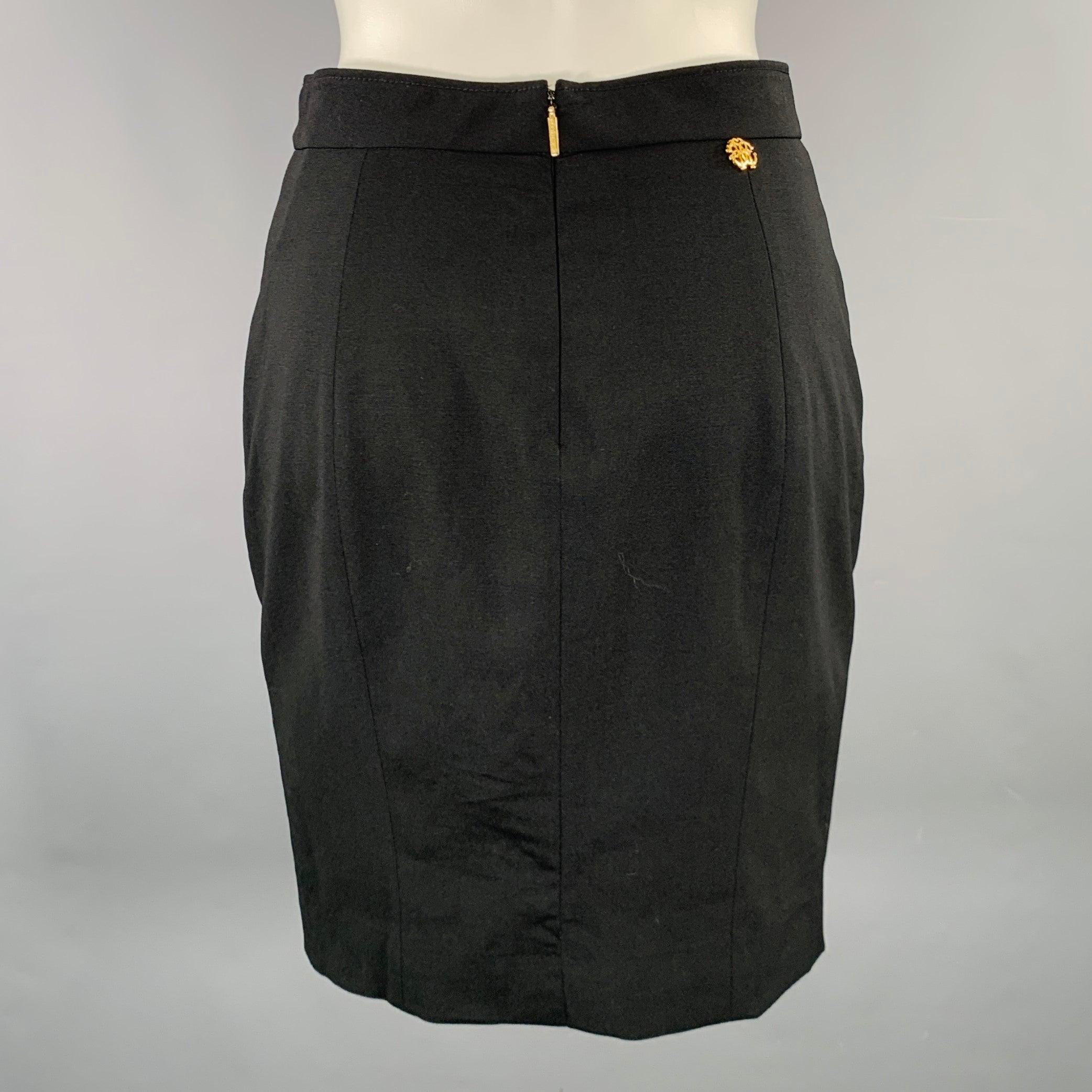 ROBERTO CAVALLI
skirt in a black wool stretch blend fabric featuring a pencil style, gold tone metal monogram detail, and back zipper closure. Made in Italy.Excellent Pre-Owned Condition. 

Marked:   size not marked. 

Measurements: 
  Waist: 26