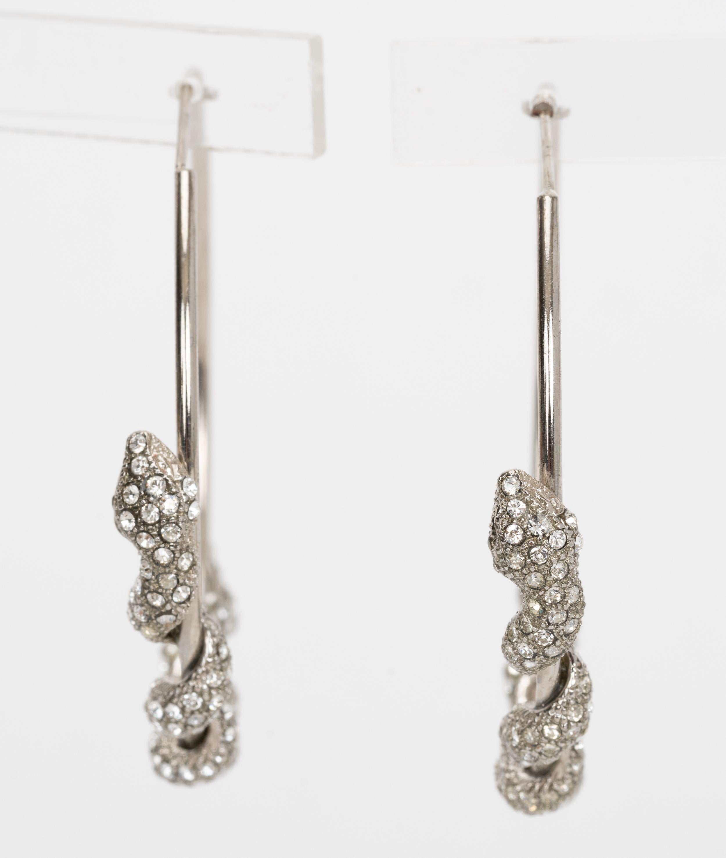 Roberto Cavalli Snake Hoop Earrings with silver toned crystal embellished snake wrapped earrings are edgy but elegant all at the same time. Come with velvet pouch.