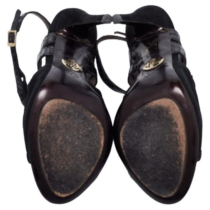 A fashionable pair of sandals that are bound to look great with mini as well as midi hemlines. These black sandals by Roberto Cavalli are crafted from snakeskin-embossed leather and suede and are designed with buckled ankle straps, smooth insoles,