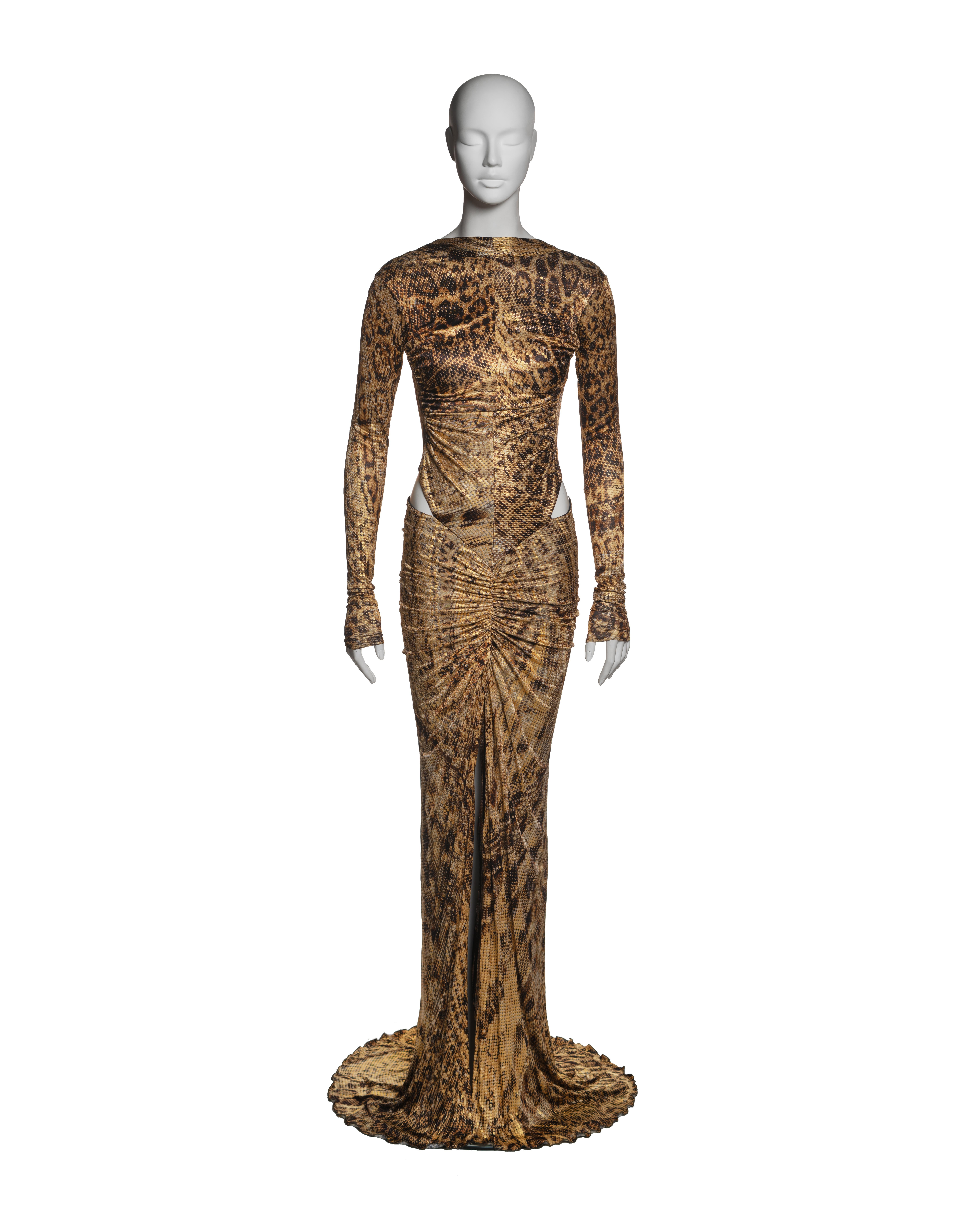 This Roberto Cavalli evening dress from the Fall-Winter 2003 collection is constructed from viscose jersey featuring an intricate snakeskin and leopard print in shades of brown and beige, with an applied gold foil overlay using a lamination