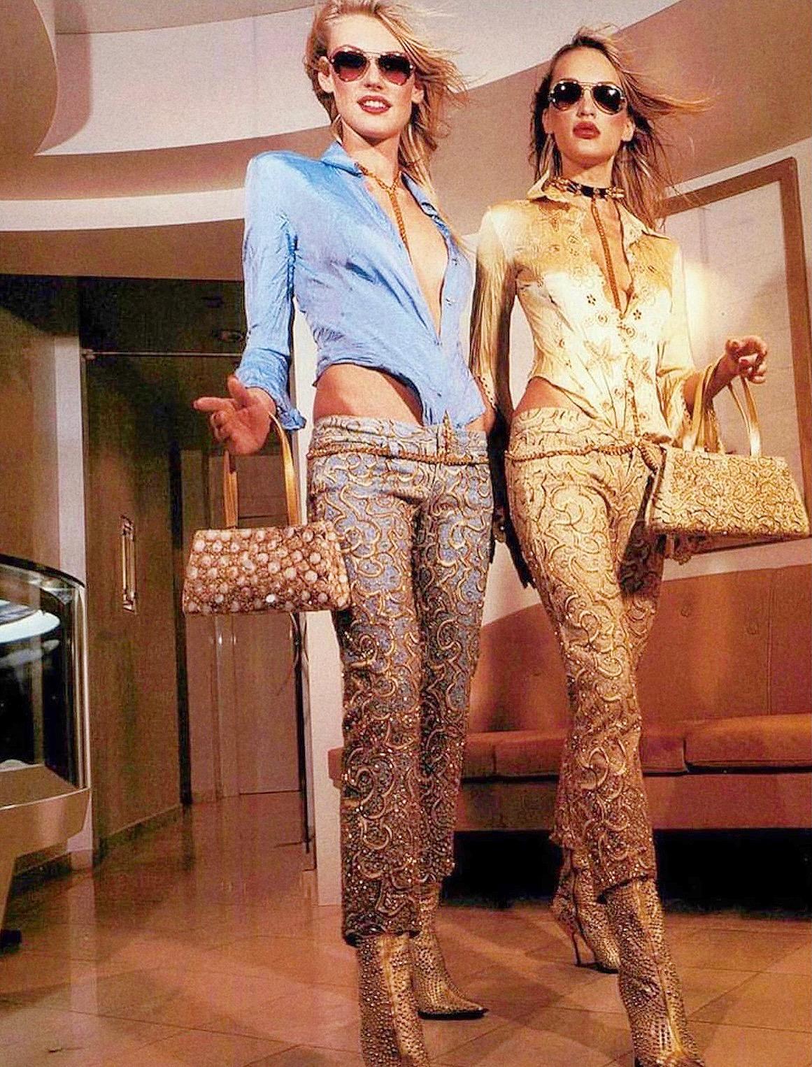 Iconic jeans as seen on Roberto Cavalli Spring 2000 campaign and same style in gold was seen on Aaliyah. With micro glitter finishing and heavily beaded legs - look stunning in person! 

Size M.

Measurements (flat lay on one side):

Waist - 38 cm