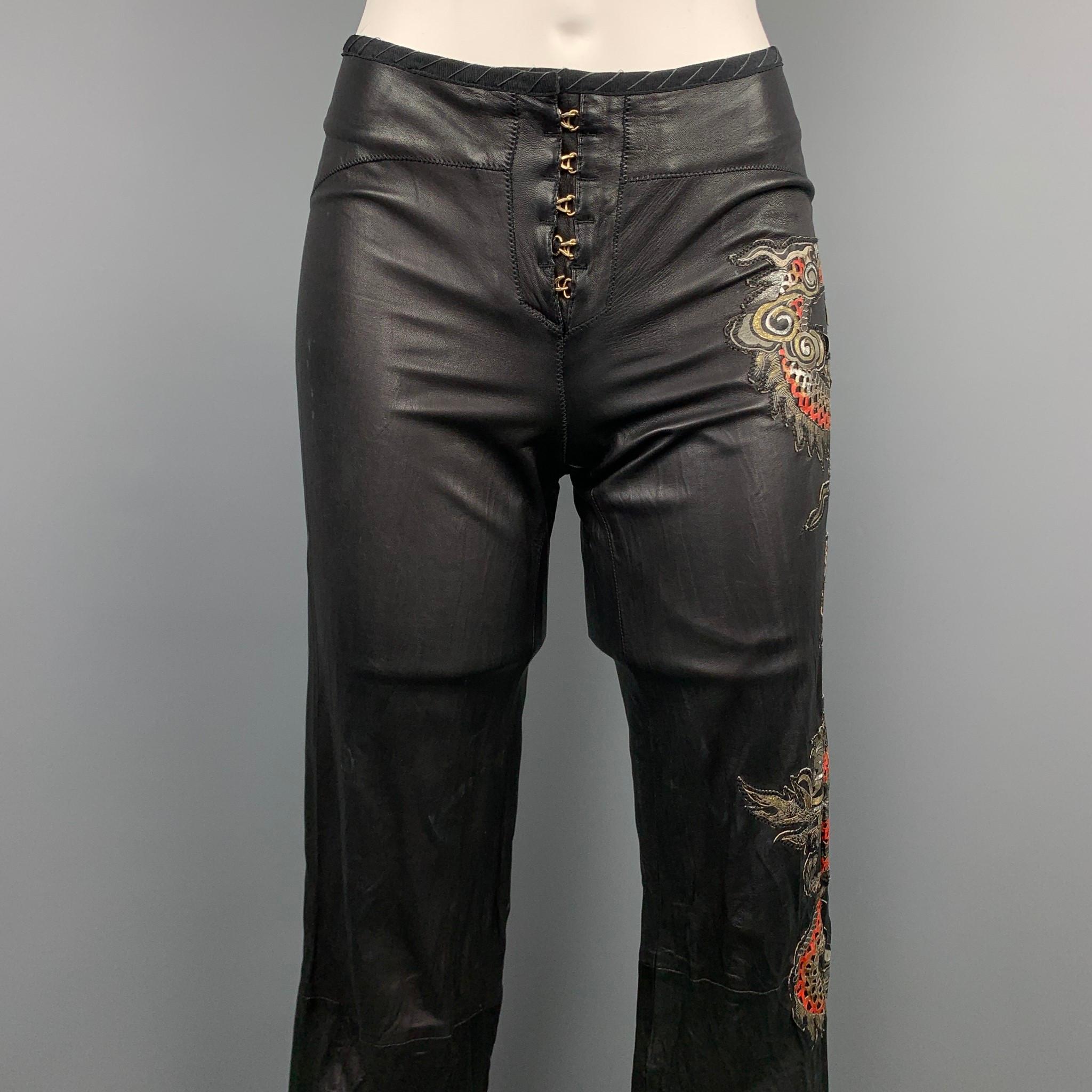 ROBERTO CAVALLI Spring 2003 pants comes in a black & red leather with a embroidered dragon design featuring a straight leg, leg zippers, and front hook fly closure. Moderate wear. Made in Italy.

Good Pre-Owned Condition.
Marked: No size