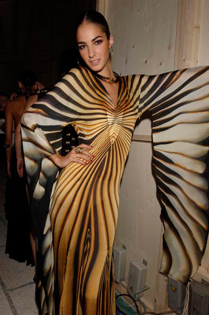 Roberto Cavalli mini kaftan dress, from the Spring/Summer 2007 collection. Zebra printed silk with flared butterfly bell sleeves. The long version as seen on the runway.

Condition
Good. Some pulled threads throughout. Pin size hole near neckline