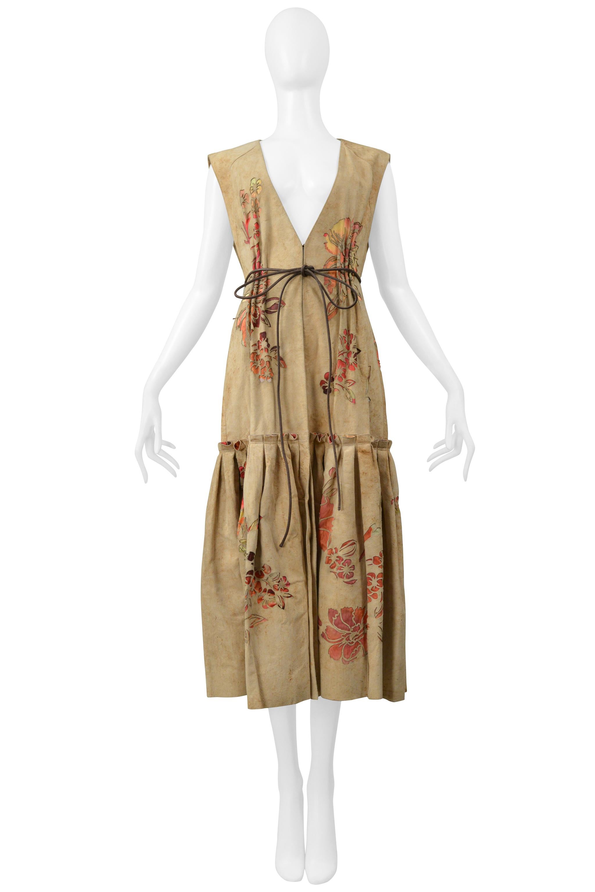 Resurrection Vintage is delighted to present a vintage Roberto Cavalli suede vest dress. This exquisite piece features a laser-cut floral print backed by a contrasting silk floral print, faux distressed look, a hook and eye waist closure, a brown