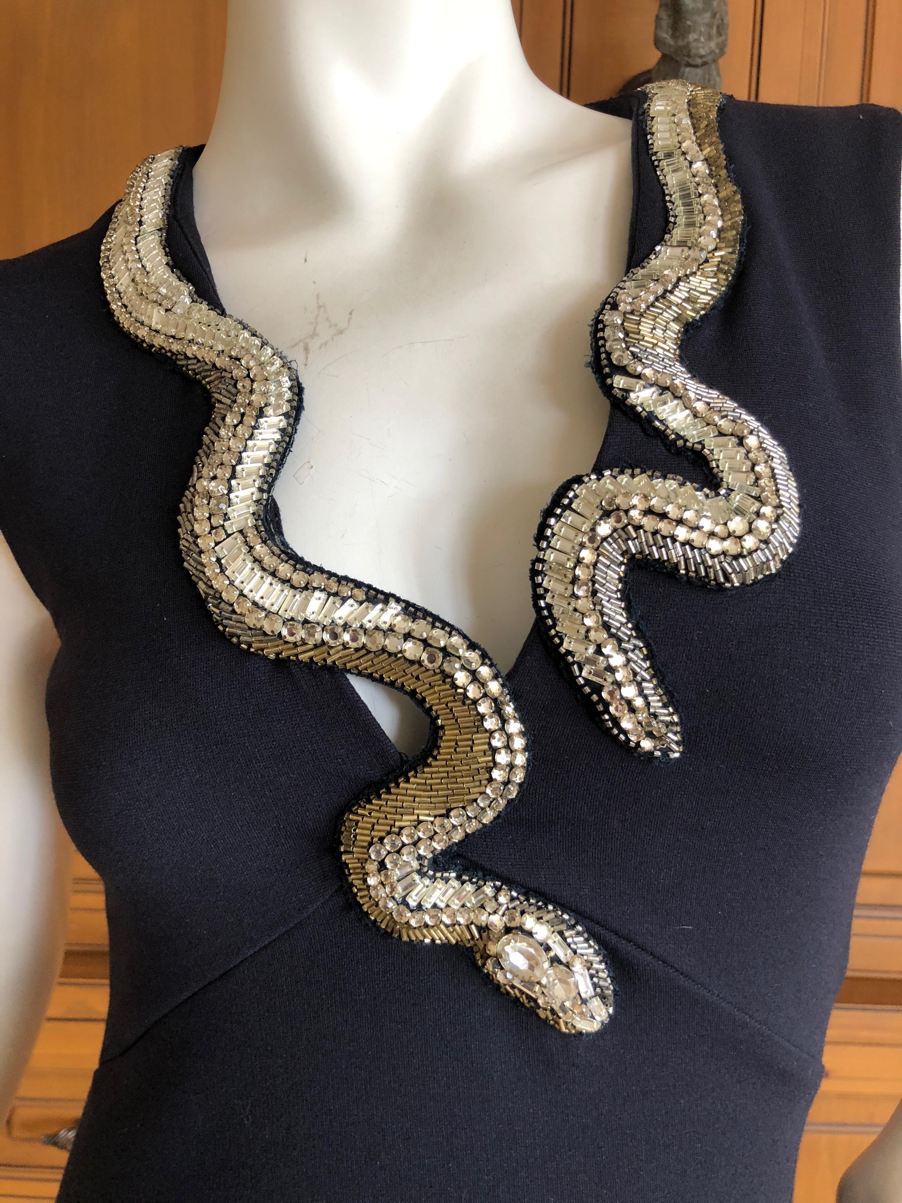 Roberto Cavalli Vintage Black Bodycon Dress with Embellished Snake Collar.
Who created the first snake embellished fashion? Ask Eve.
This is amazing, very stretchy dress, hugs all the right places.
 Size 46
 Bust 38