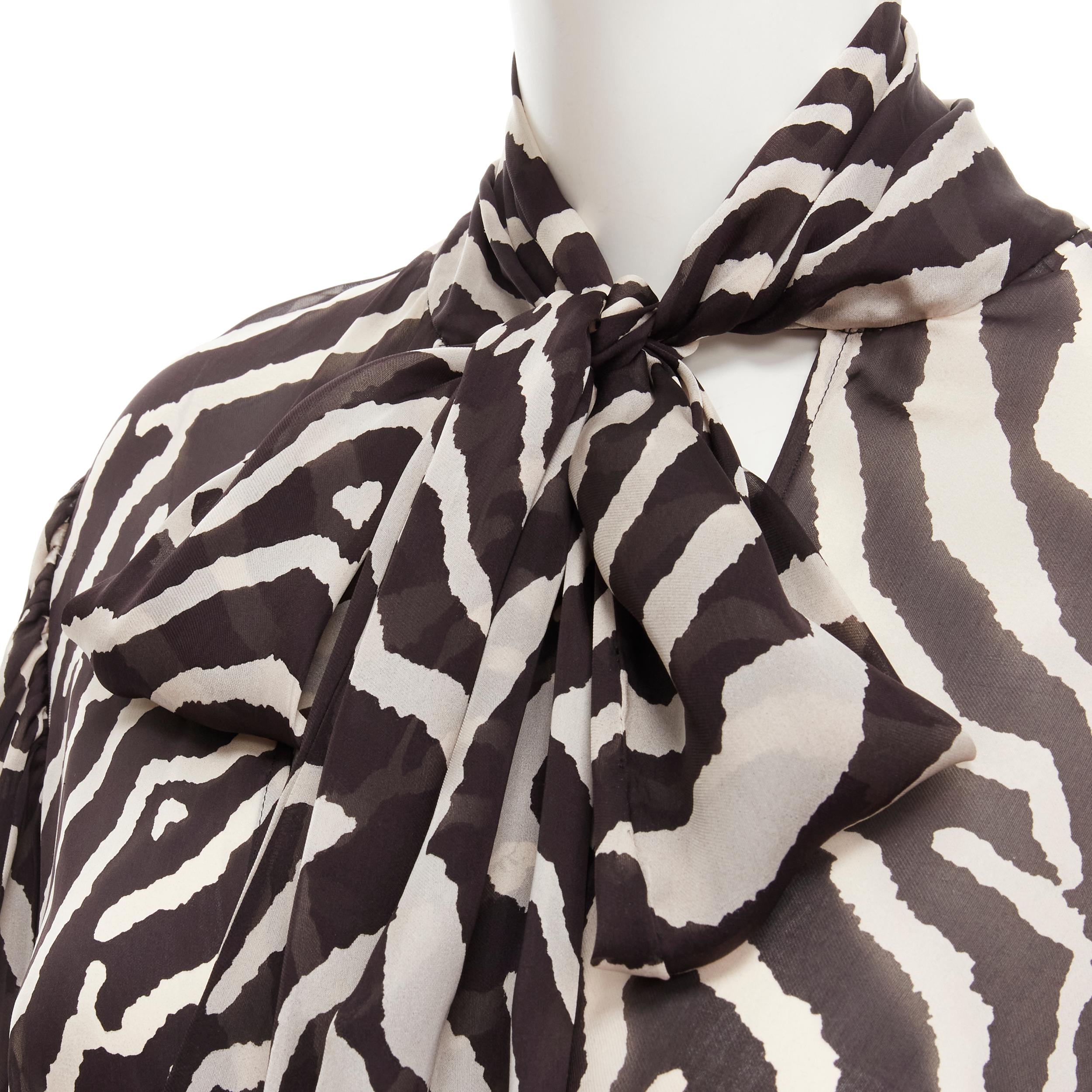 ROBERTO CAVALLI VIntage brown zebra striped print pussy bow silk blouse IT44 M 
Reference: GIYG/A00207 
Brand: Roberto Cavalli 
Material: Silk 
Color: Black 
Pattern: Zebra 
Closure: Button 
Extra Detail: Elasticated belt at inside to create a