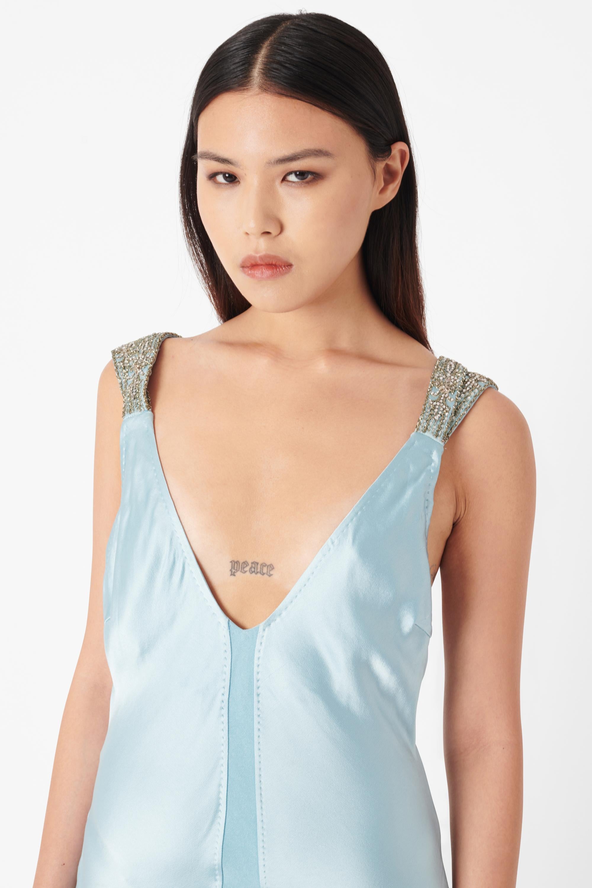 Vintage Deadstock 2005 Roberto Cavalli Baby Blue Silk Maxi Dress. The dress features 100% Silk in Baby blue in a maxi length with 4 1” thick straps embellished with intricate silver bead, sequin and diamante detailing. The skirt is made up of