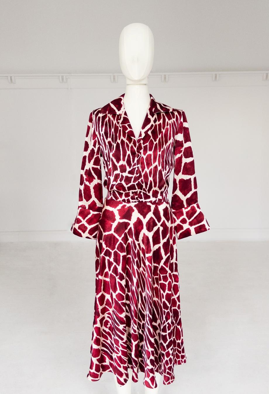 Famously worn by Carrie Bradshaw in Sex and The City, this incredibly rare vintage Roberto Cavalli dress is a true collector's piece. Crafted from luxurious silk, it showcases a striking giraffe-inspired print in deep burgundy and ivory tones. The