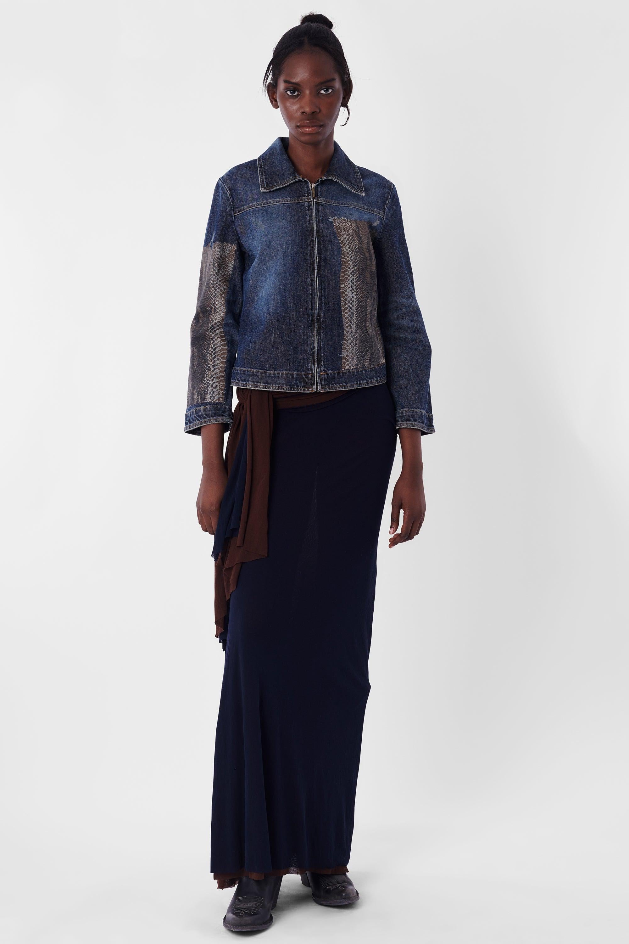 We are excited to present this Roberto Cavalli Vintage Snakeskin Denim Jacket. Features snake skin patches, cropped boxy fit, collar, contrast stitching and zipper down front for closure. In excellent vintage condition. Authenticity