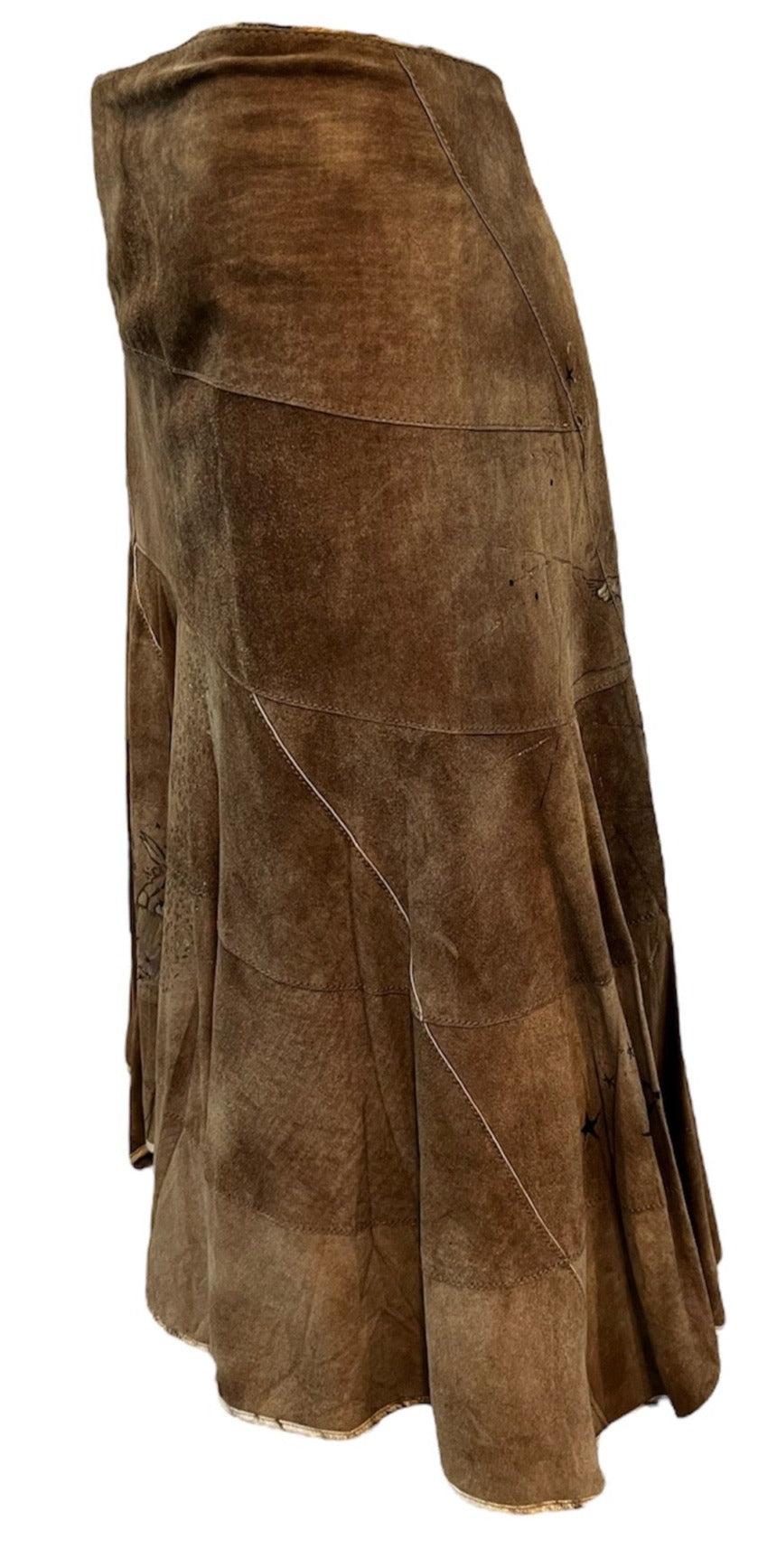 Early 2000s era Roberto Cavalli skirt in shades of brown suede. Patchwork in  slinky bias cut. Mid length. Hand painted celestial scene. Fully lined and in new with tags condition.

Additional information:
Dimensions:
Waist: 34