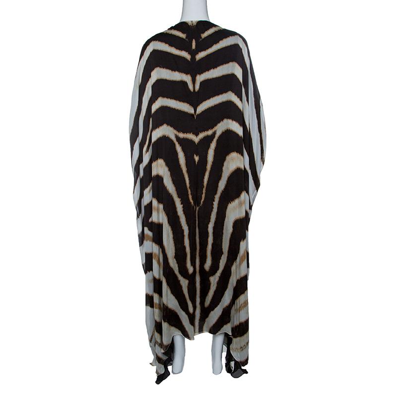 Playful and feminine, this maxi dress from Roberto Cavalli features a zebra print throughout in a refreshing silhouette. It is crafted with silk and is detailed with cutout sleeves. Offering a slightly loose fitting, wear this with flat sandals or